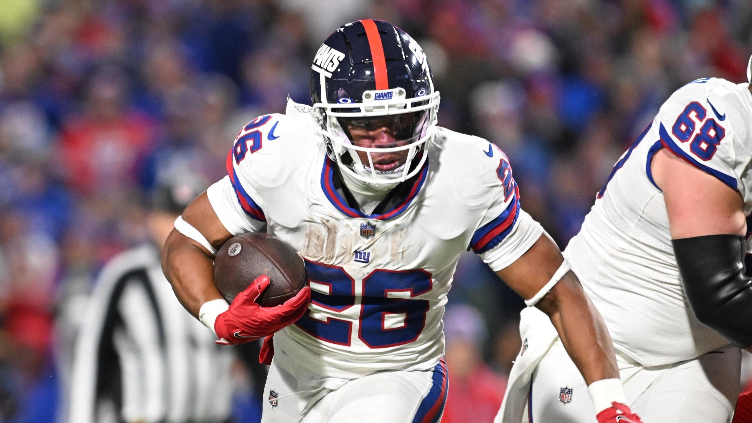 Oct 15, 2023; Orchard Park, New York, USA; New York Giants running back Saquon Barkley (26) carries the ball against the Buffalo Bills in the fourth quarter at Highmark Stadium.