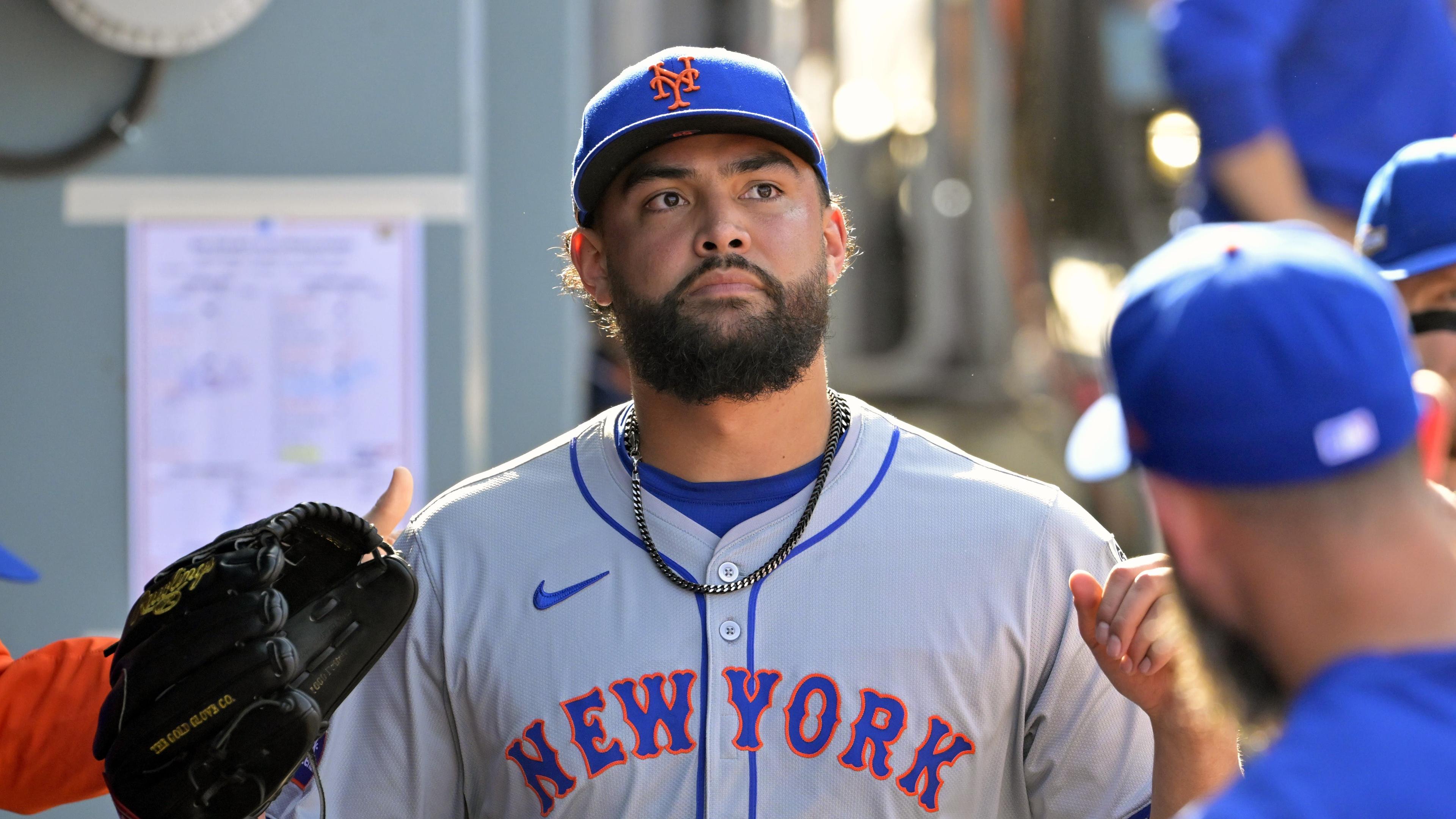 Oct 14, 2024; Los Angeles, California, USA; New York Mets pitcher Sean Manaea (59) greets teammates in the dugout after being relieved in the sixth inning against the Los Angeles Dodgers during game two of the NLCS for the 2024 MLB Playoffs at Dodger Stadium. Mandatory Credit: Jayne Kamin-Oncea-Imagn Images