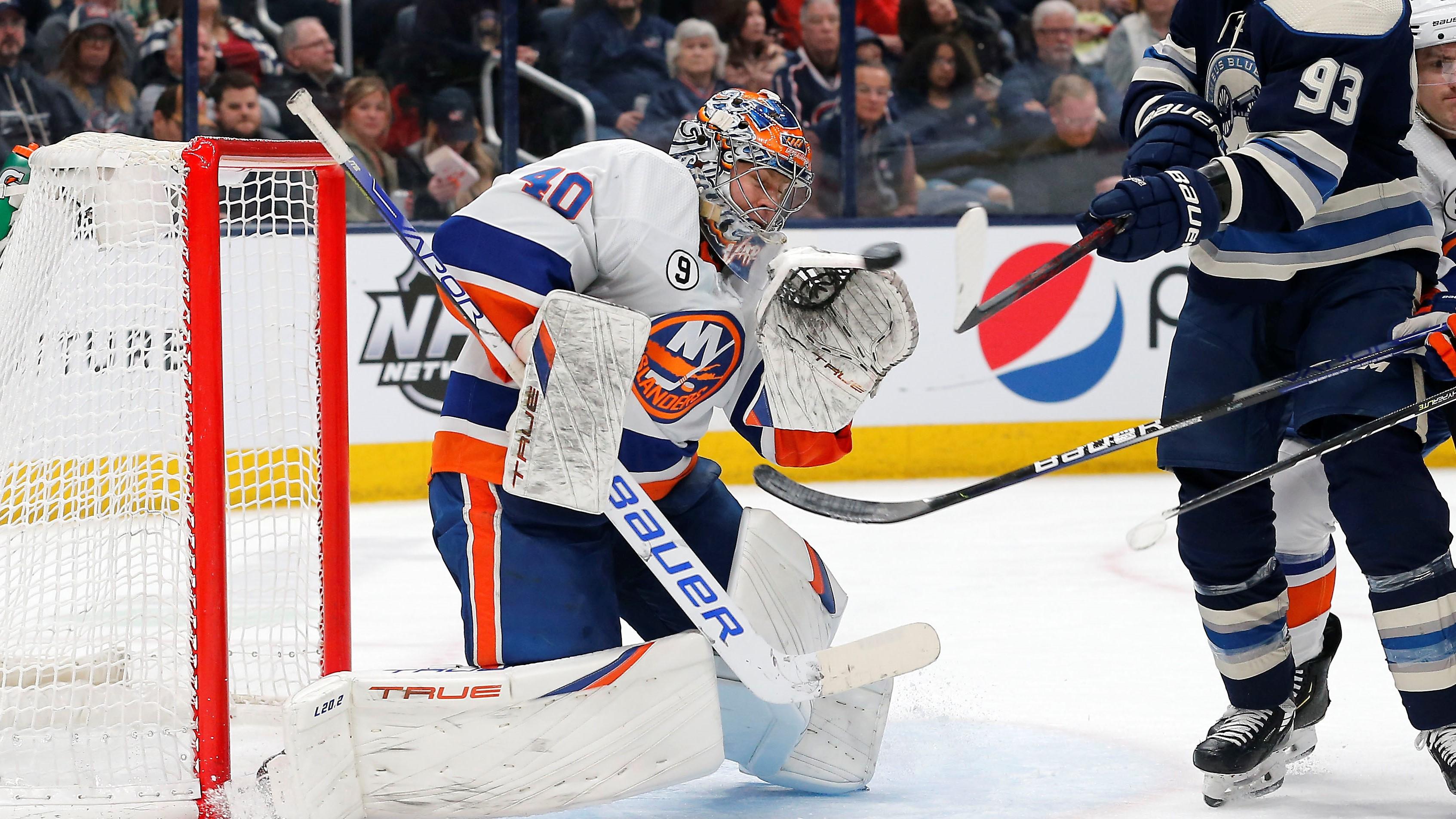 Mar 29, 2022; Columbus, Ohio, USA; New York Islanders goalie Semyon Varlamov (40) makes a save as Columbus Blue Jackets right wing Jakub Voracek (93) reaches for the puckduring the second period at Nationwide Arena. Mandatory Credit: Russell LaBounty-USA TODAY Sports