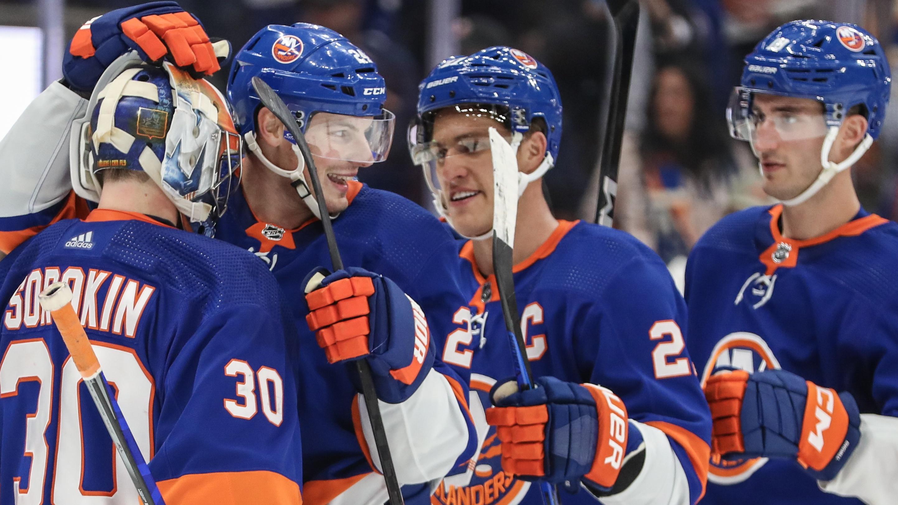 The New York Islanders celebrate after defeating the Buffalo Sabres 3-2 at UBS Arena