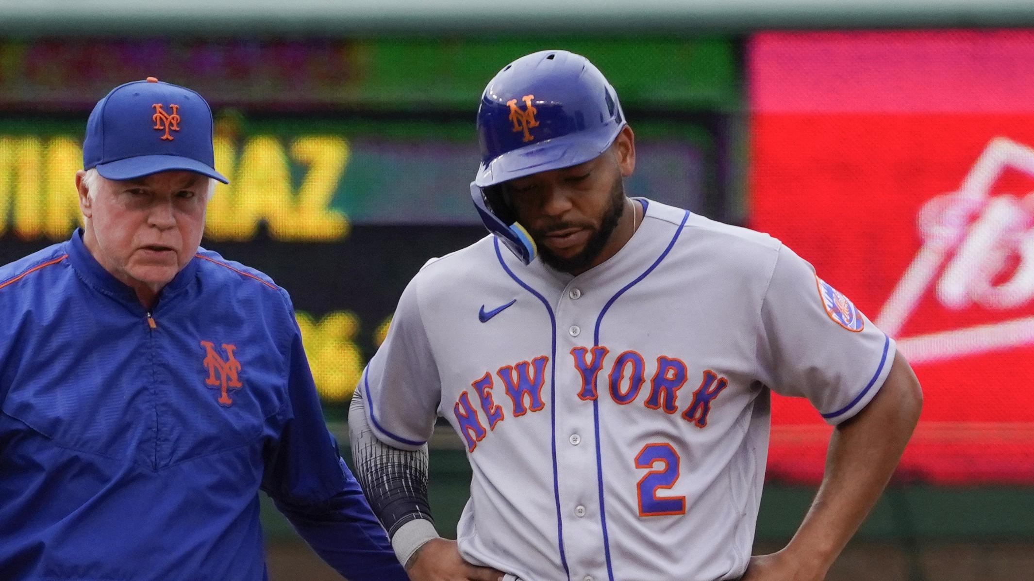 Jul 16, 2022; Chicago, Illinois, USA; New York Mets manager Buck Showalter (11) walks with New York Mets first baseman Dominic Smith (2) after Smith injured himself during the tenth inning in game one of a doubleheader at Wrigley Field. Mandatory Credit: David Banks-USA TODAY Sports