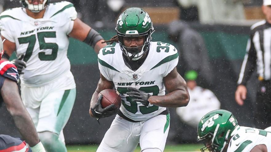 Sep 24, 2023; East Rutherford, New Jersey, USA; New York Jets running back Dalvin Cook (33) carries the ball asNew England Patriots linebacker Ja'Whaun Bentley (8) defends during the second half at MetLife Stadium.