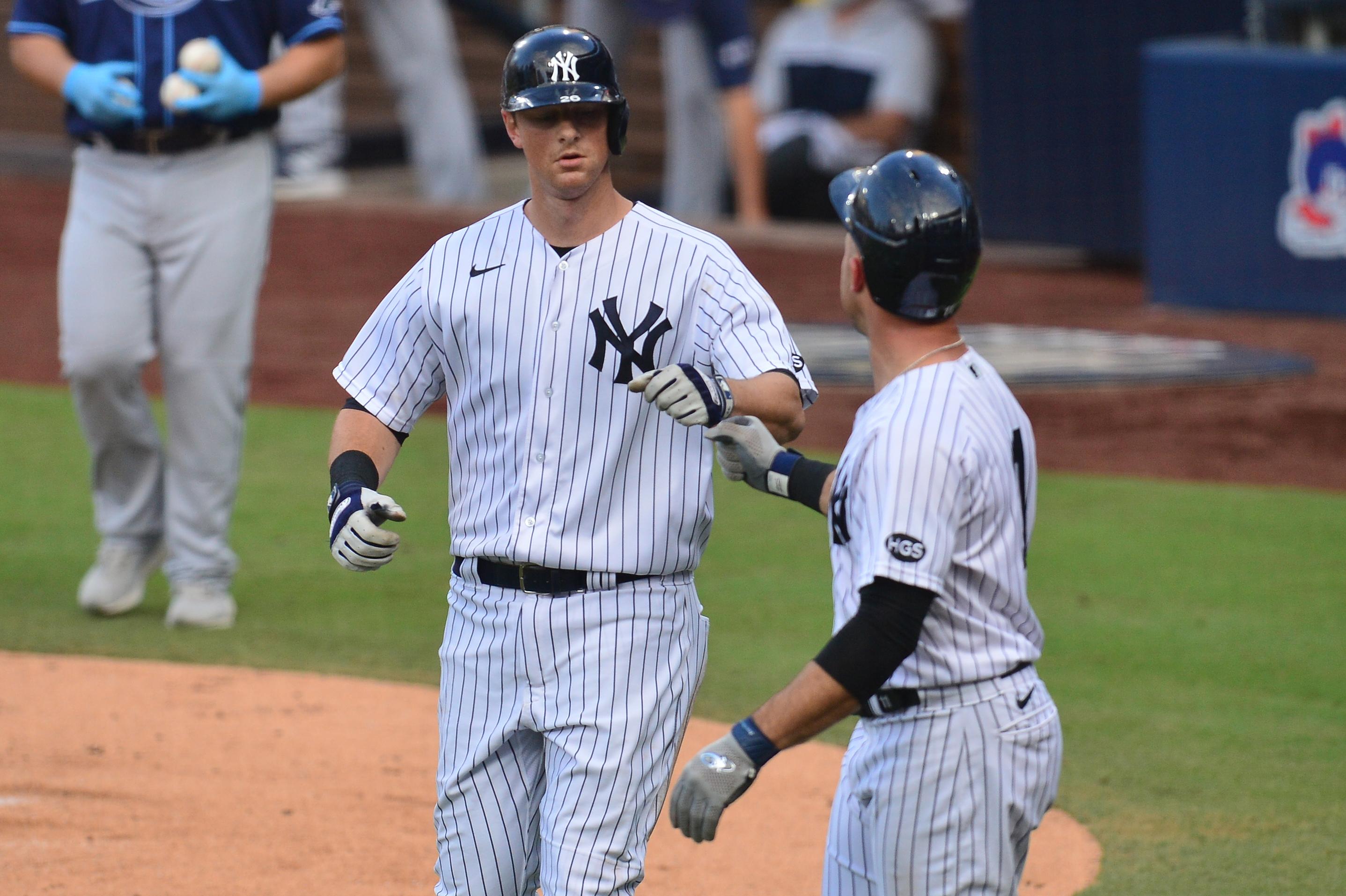 Oct 8, 2020; San Diego, California, USA; New York Yankees second baseman DJ LeMahieu (left) celebrates with left fielder Brett Gardner (right) after driving in in Gardner with a sacrifice fly ball against the Tampa Bay Rays during the second inning of game four of the 2020 ALDS at Petco Park. Mandatory Credit: Gary A. Vasquez-USA TODAY Sports