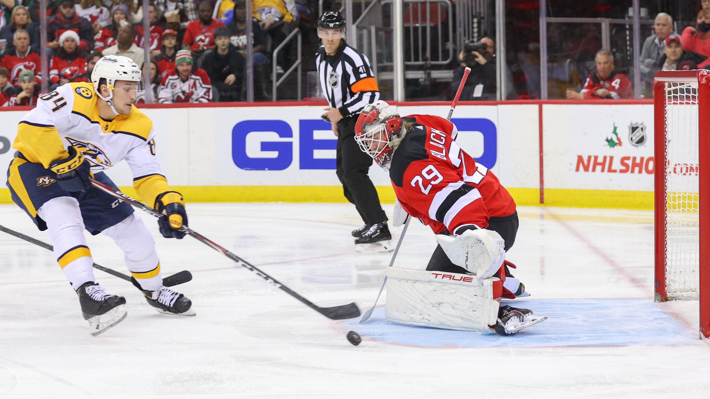 Dec 10, 2021; Newark, New Jersey, USA; Nashville Predators left wing Tanner Jeannot (84) shoots the puck wide of New Jersey Devils goaltender Mackenzie Blackwood (29) during the first period at Prudential Center.