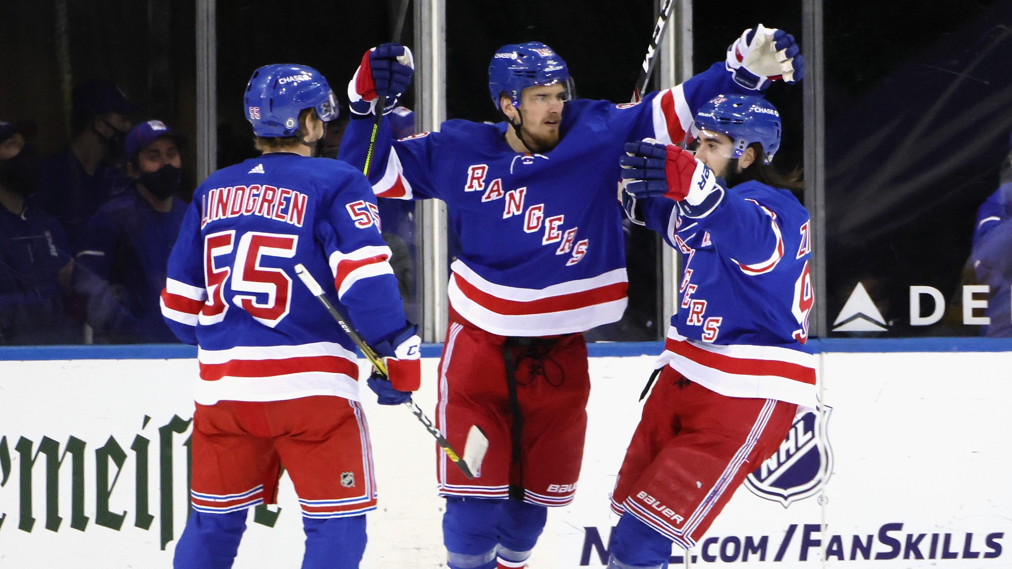 Apr 6, 2021; New York, New York, USA; Mika Zibanejad #93 of the New York Rangers (R) celebrates his goal at 7:28 of the first period against the Pittsburgh Penguins and is joined by Ryan Lindgren #55 (L) and Pavel Buchnevich #89 (C) at Madison Square Garden on April 06, 2021 in New York City..