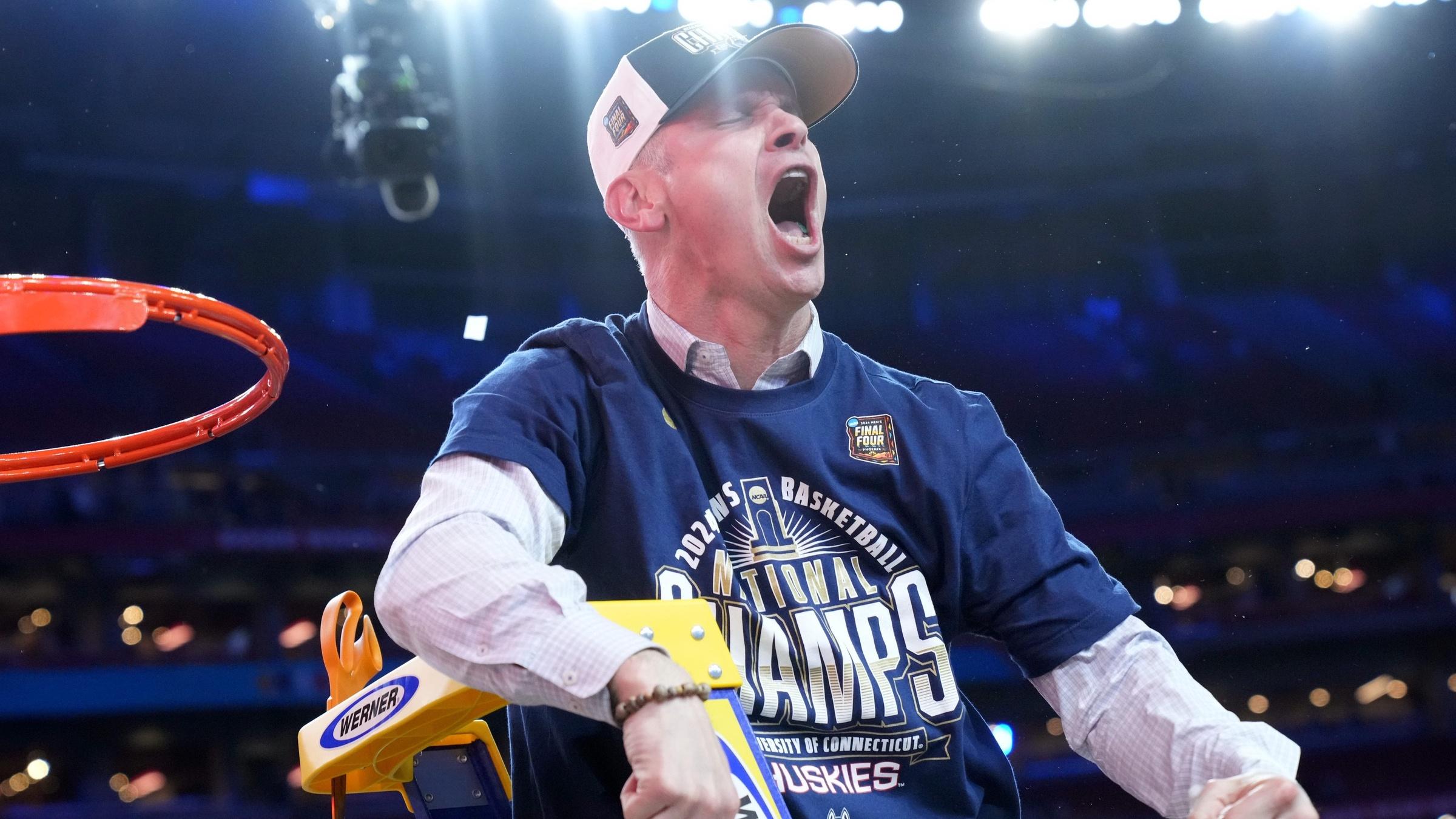 Connecticut Huskies head coach Dan Hurley cuts down the cut after defeating the Purdue Boilermakers in the national championship game of the Final Four of the 2024 NCAA Tournament at State Farm Stadium in Glendale on April 8, 2024.