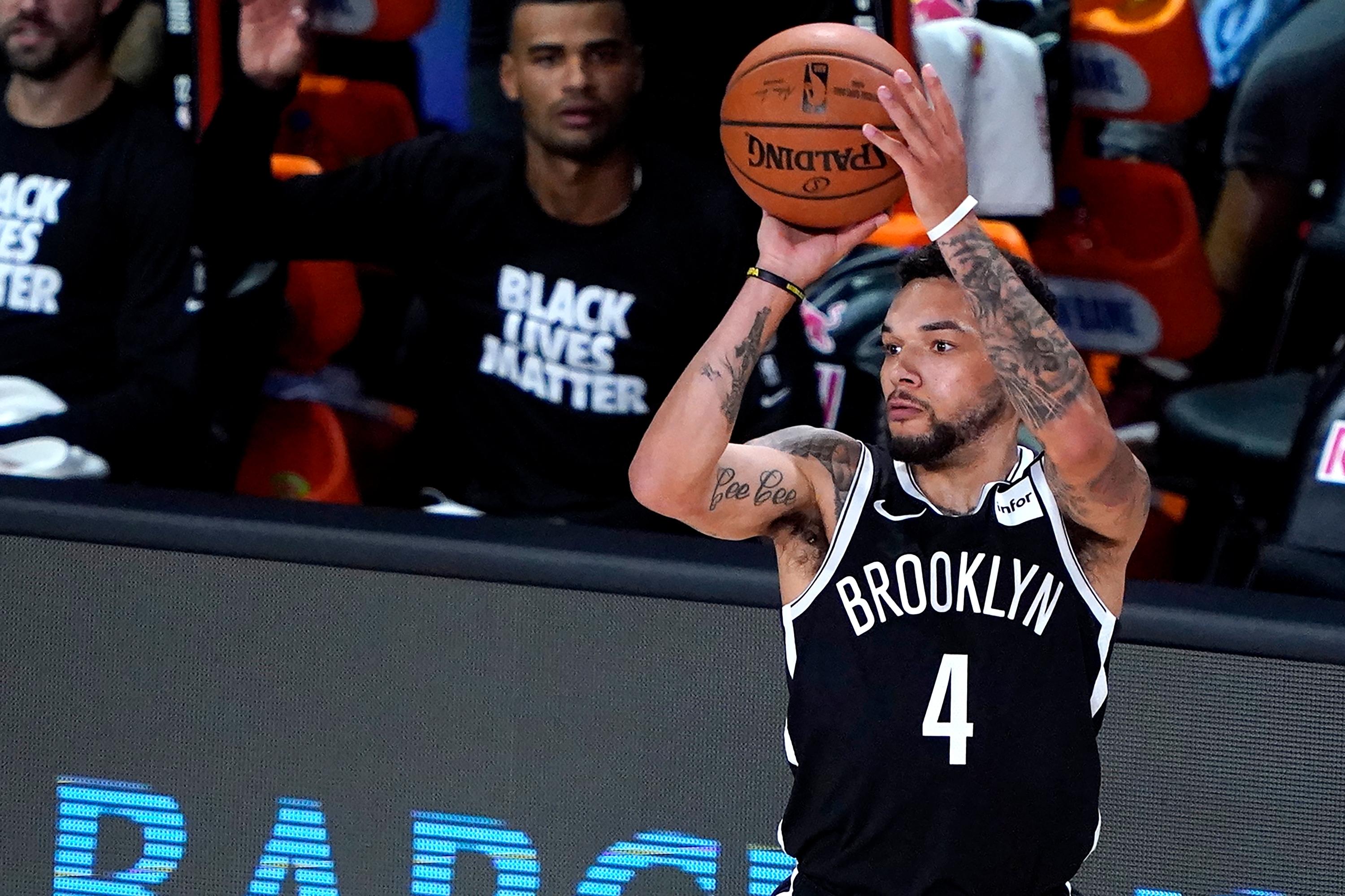 Aug 7, 2020; Lake Buena Vista, Florida, USA; Brooklyn Nets' Chris Chiozza (4) shoots against the Sacramento Kings during the first half of an NBA basketball game at The Arena.