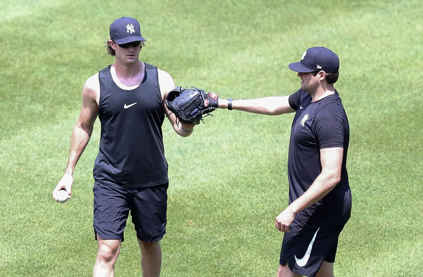 Jul 6, 2020; Bronx, New York, United States; New York Yankees starting pitcher Gerrit Cole (left) touches gloves with starting pitcher Jordan Montgomery (right) during workouts at Yankee Stadium. Mandatory Credit: Vincent Carchietta-USA TODAY Sports / Vincent Carchietta-USA TODAY Sports