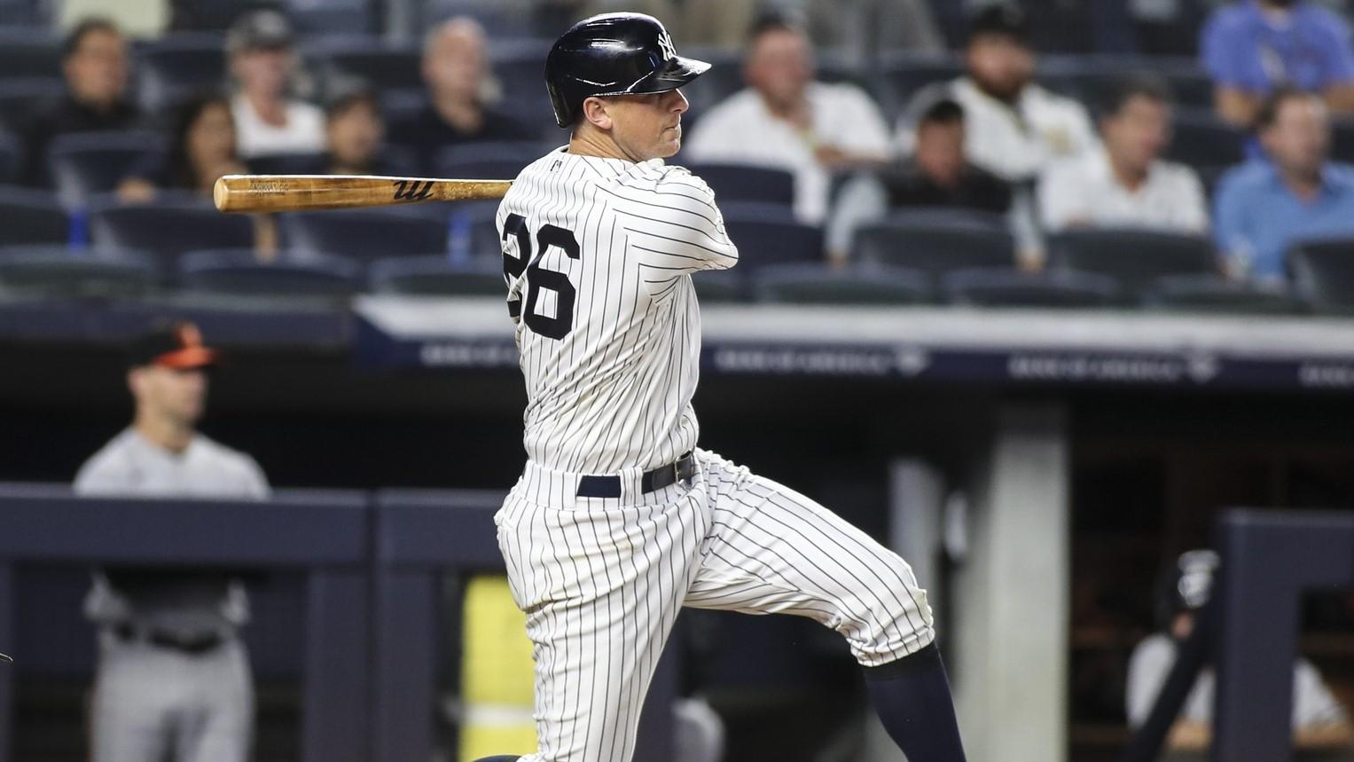 New York Yankees third baseman DJ LeMahieu (26) hits an RBI single in the seventh inning against the Baltimore Orioles at Yankee Stadium.