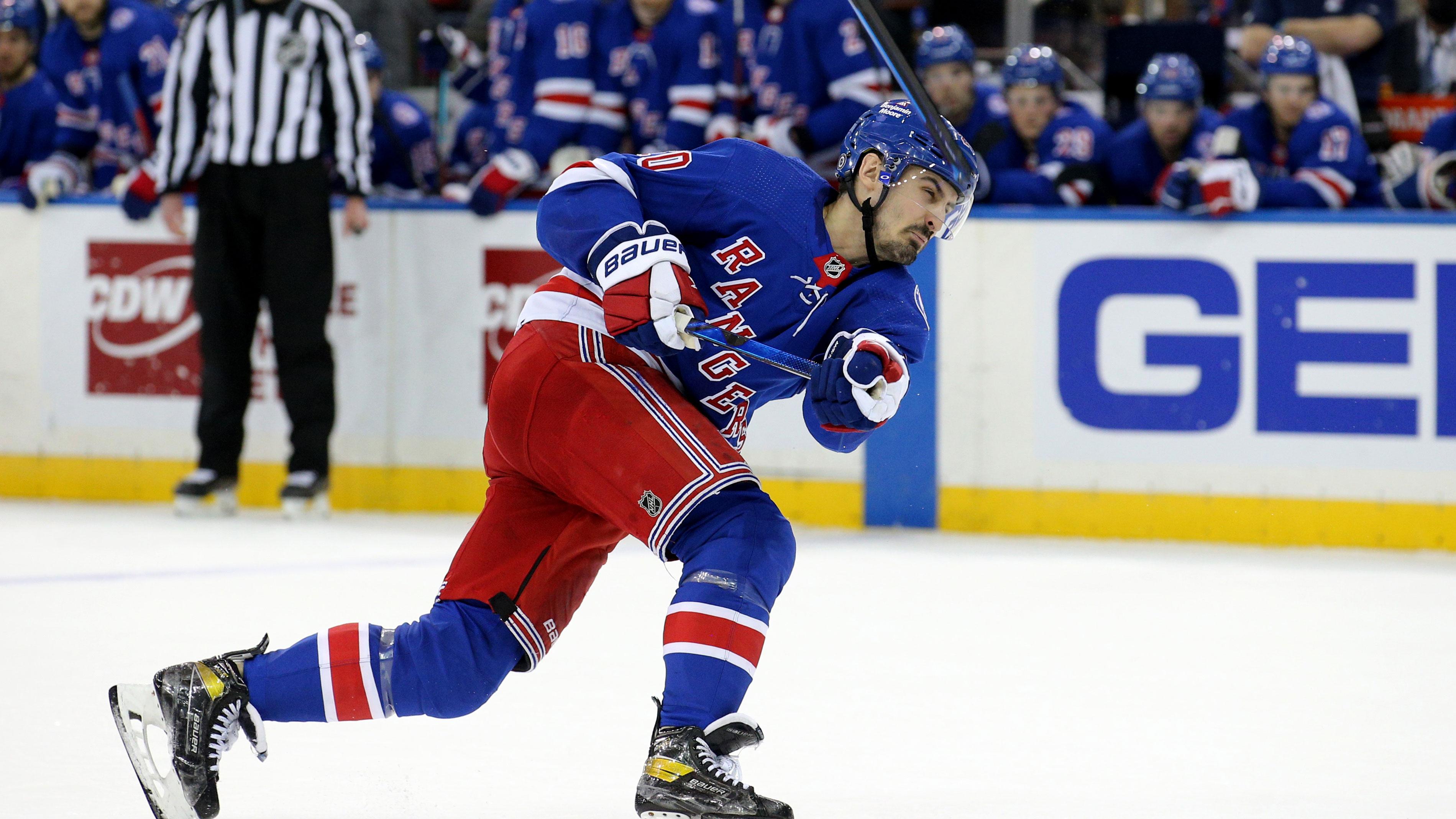 Dec 17, 2021; New York, New York, USA; New York Rangers left wing Chris Kreider (20) breaks his stick as he shoots against the Vegas Golden Knights during overtime at Madison Square Garden.