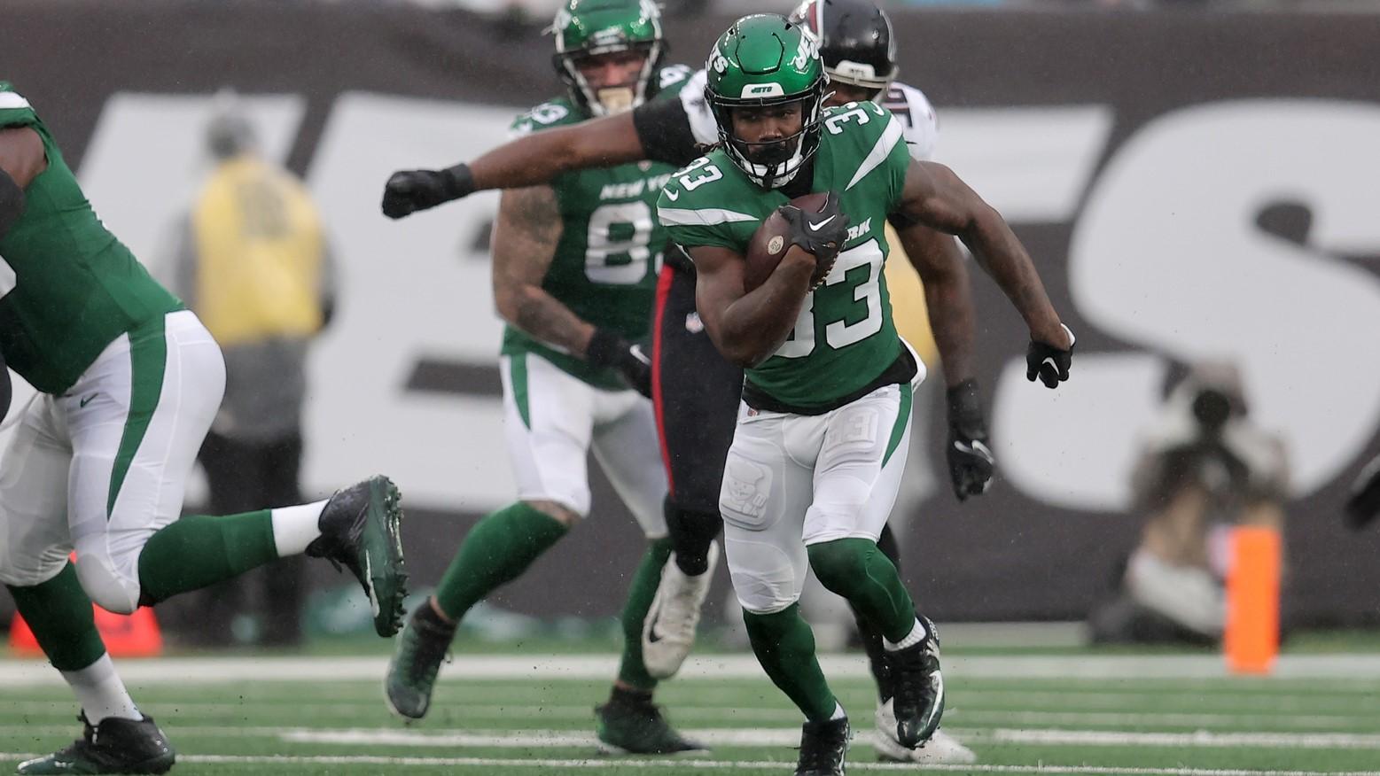 Dec 3, 2023; East Rutherford, New Jersey, USA; New York Jets running back Dalvin Cook (33) runs with the ball against the Atlanta Falcons during the first quarter at MetLife Stadium.