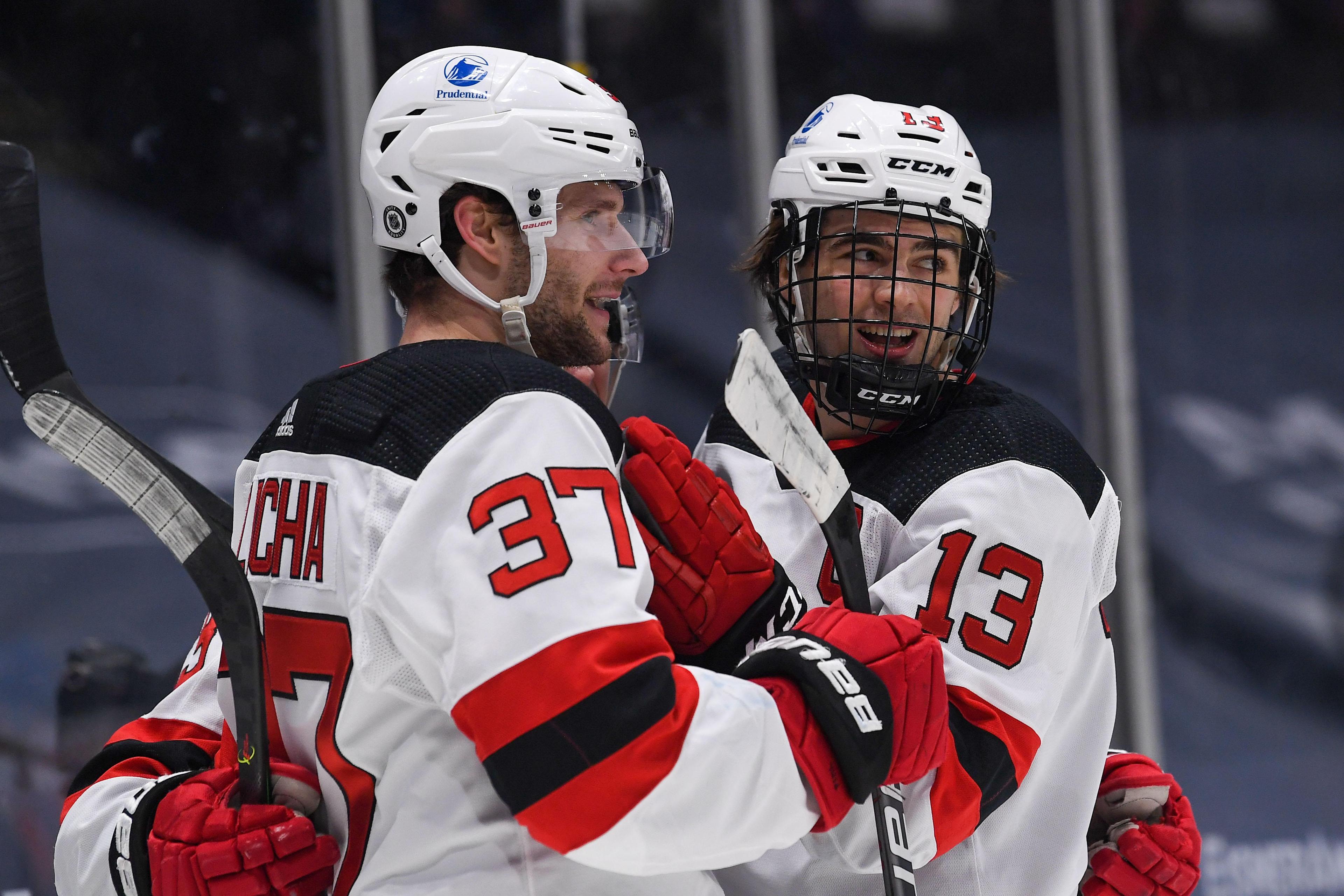 May 6, 2021; Uniondale, New York, USA; New Jersey Devils center Nico Hischier (13) celebrates the goal by New Jersey Devils center Pavel Zacha (37) against the New York Islanders during the first period at Nassau Veterans Memorial Coliseum.