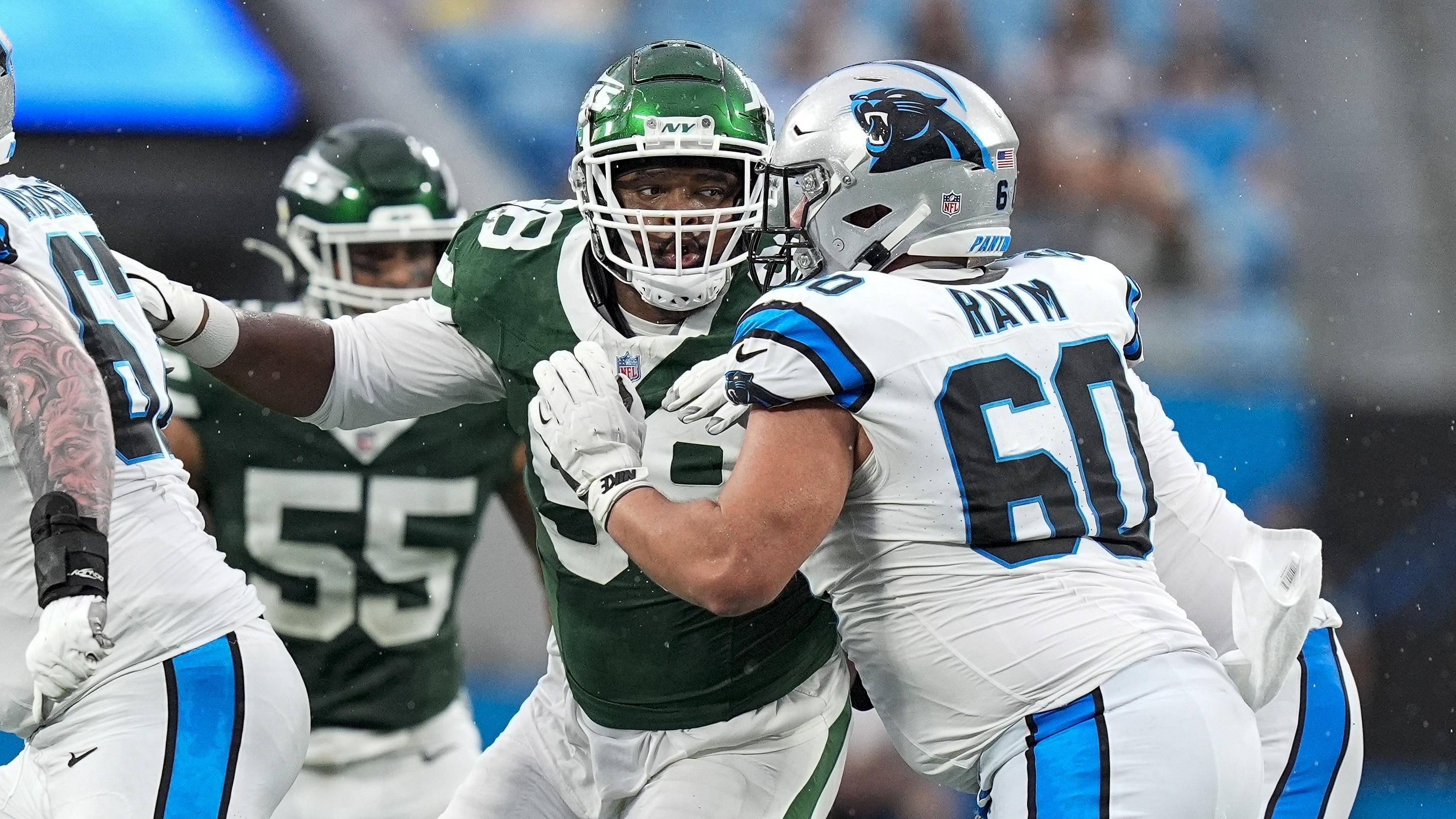 Aug 17, 2024; Charlotte, North Carolina, USA; New York Jets defensive end Will McDonald IV (99) tries to get off a block by Carolina Panthers center Andrew Raym (60) during the first quarter at Bank of America Stadium. Mandatory Credit: Jim Dedmon-USA TODAY Sports