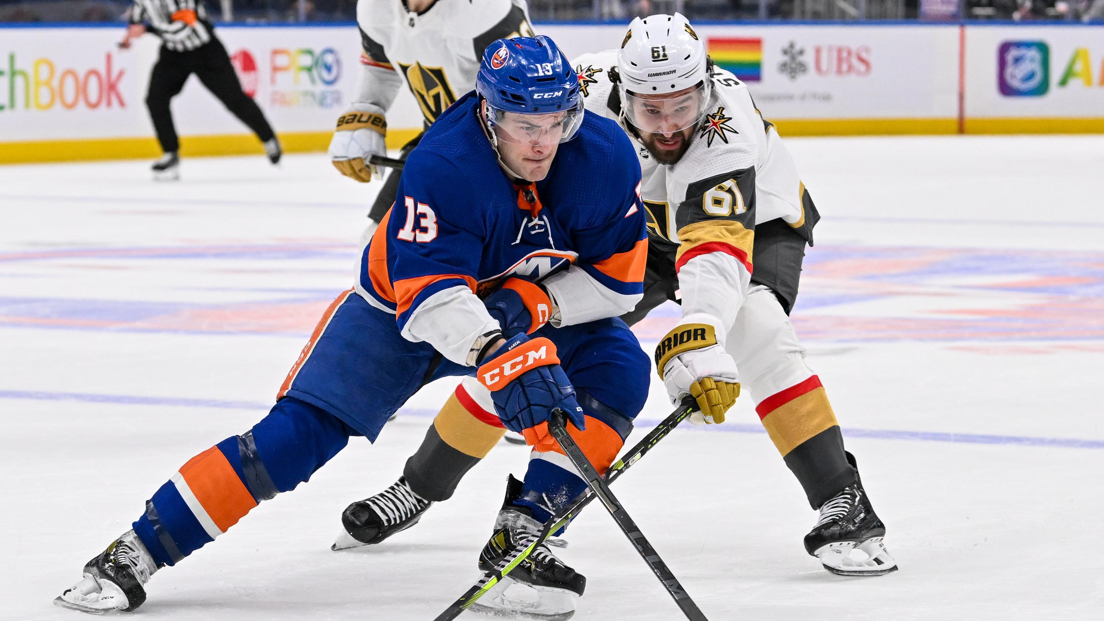 New York Islanders center Mathew Barzal (13) skates with the puck defended by Vegas Golden Knights right wing Mark Stone (61) during the second period at UBS Arena.