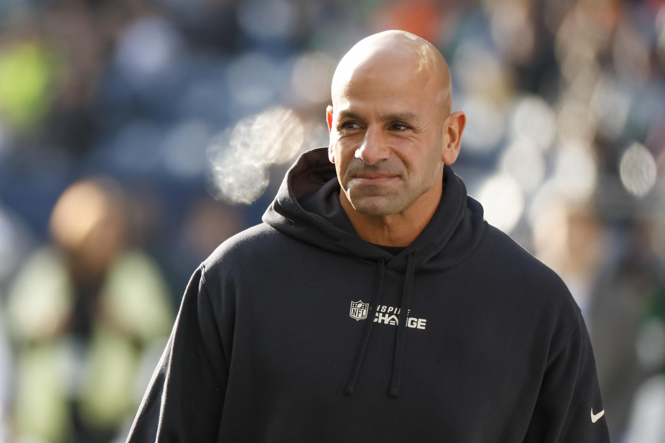 New York Jets head coach Robert Saleh watches pregame warmups against the Seattle Seahawks at Lumen Field.