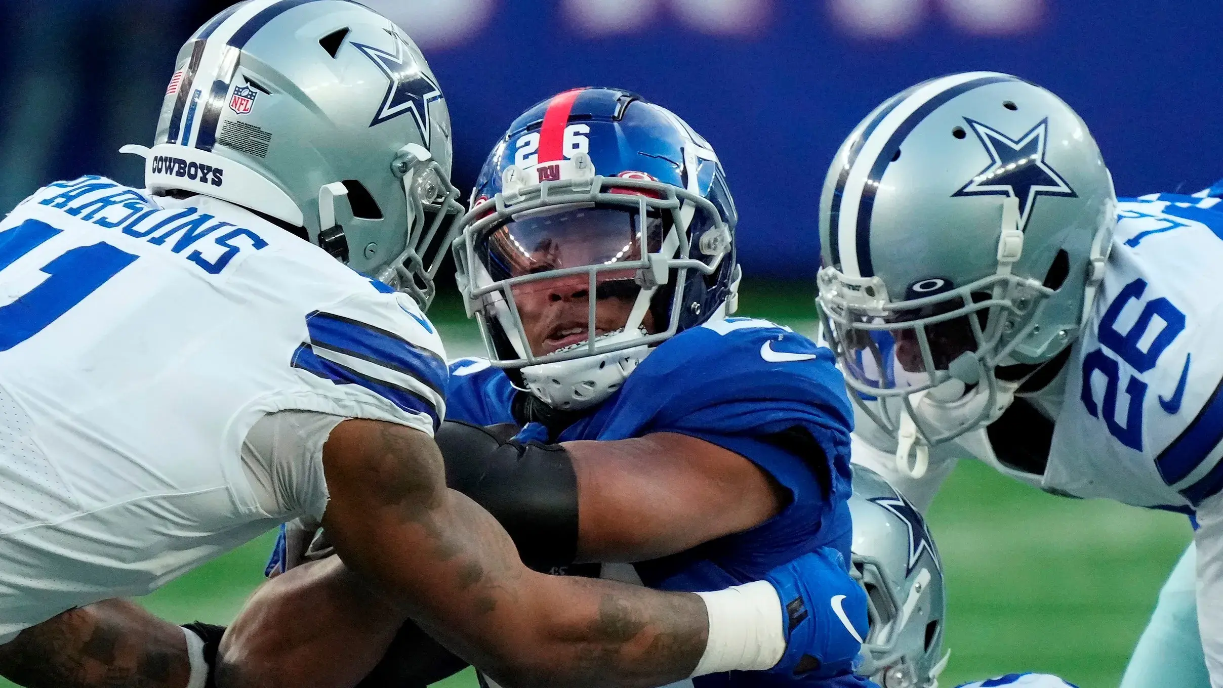 Dec 19, 2021; East Rutherford, N.J., USA; New York Giants running back Saquon Barkley (26) is stopped by the Dallas Cowboys during the second half at MetLife Stadium. Mandatory Credit: Robert Deutsch-USA TODAY Sports / Robert Deutsch-USA TODAY Sports