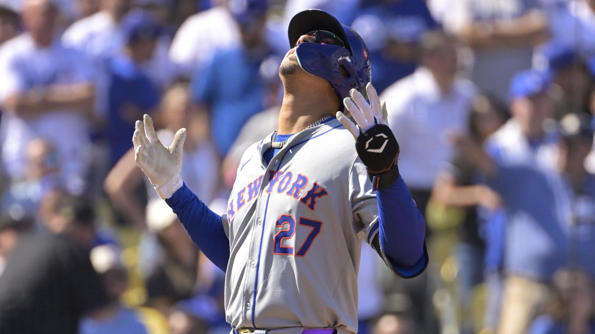 Oct 14, 2024; Los Angeles, California, USA; New York Mets third baseman Mark Vientos (27) celebrates after hitting a grand slam home run in the second inning against the Los Angeles Dodgers during game two of the NLCS for the 2024 MLB Playoffs at Dodger Stadium.