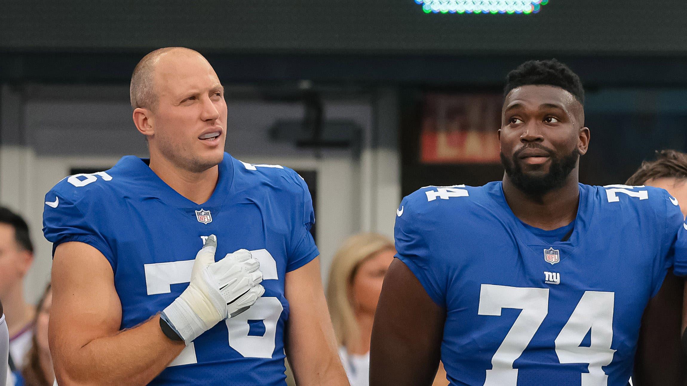 New York Giants offensive tackle Nate Solder (76) and offensive tackle Matt Peart (74) and offensive guard Chad Slade (62) and center Nick Gates (65) stand during the national anthem before the game. / Vincent Carchietta-USA TODAY Sports