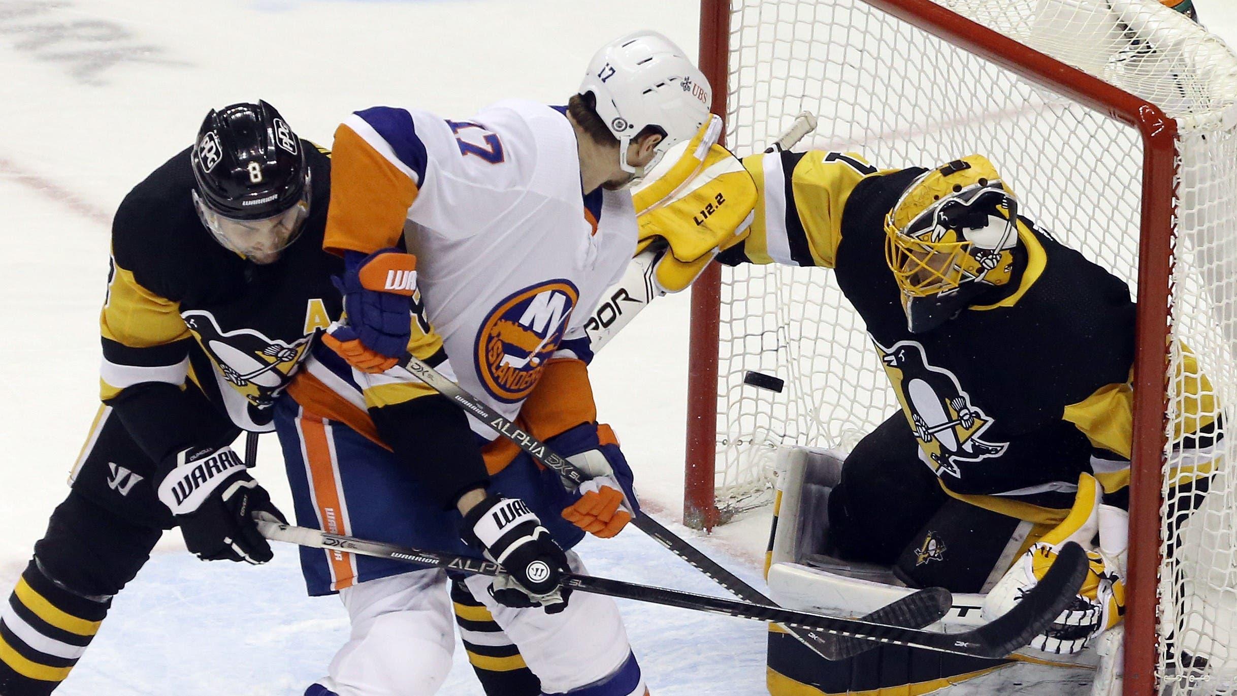 Mar 29, 2021; Pittsburgh, Pennsylvania, USA; New York Islanders left wing Matt Martin (17) deflects the puck past Pittsburgh Penguins goaltender Casey DeSmith (1) to score a goal during the second period at PPG Paints Arena / Charles LeClaire-USA TODAY Sports