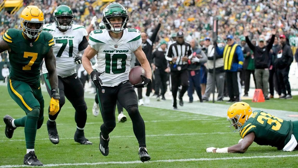 New York Jets wide receiver Braxton Berrios (10) rushing in for a touchdown after eluding Green Bay Packers safety Adrian Amos (31), right, during the third quarter of their game on Sunday, Oct. 16, 2022 at Lambeau Field in Green Bay.