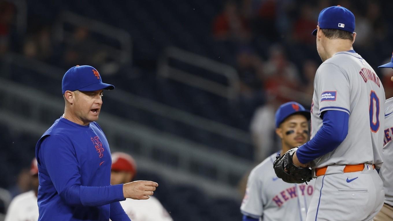 New York Mets manager Carlos Mendoza (L) walks to the mound to remove Mets pitcher Adam Ottavino (0) from the game against the Washington Nationals during the ninth inning at Nationals Park.