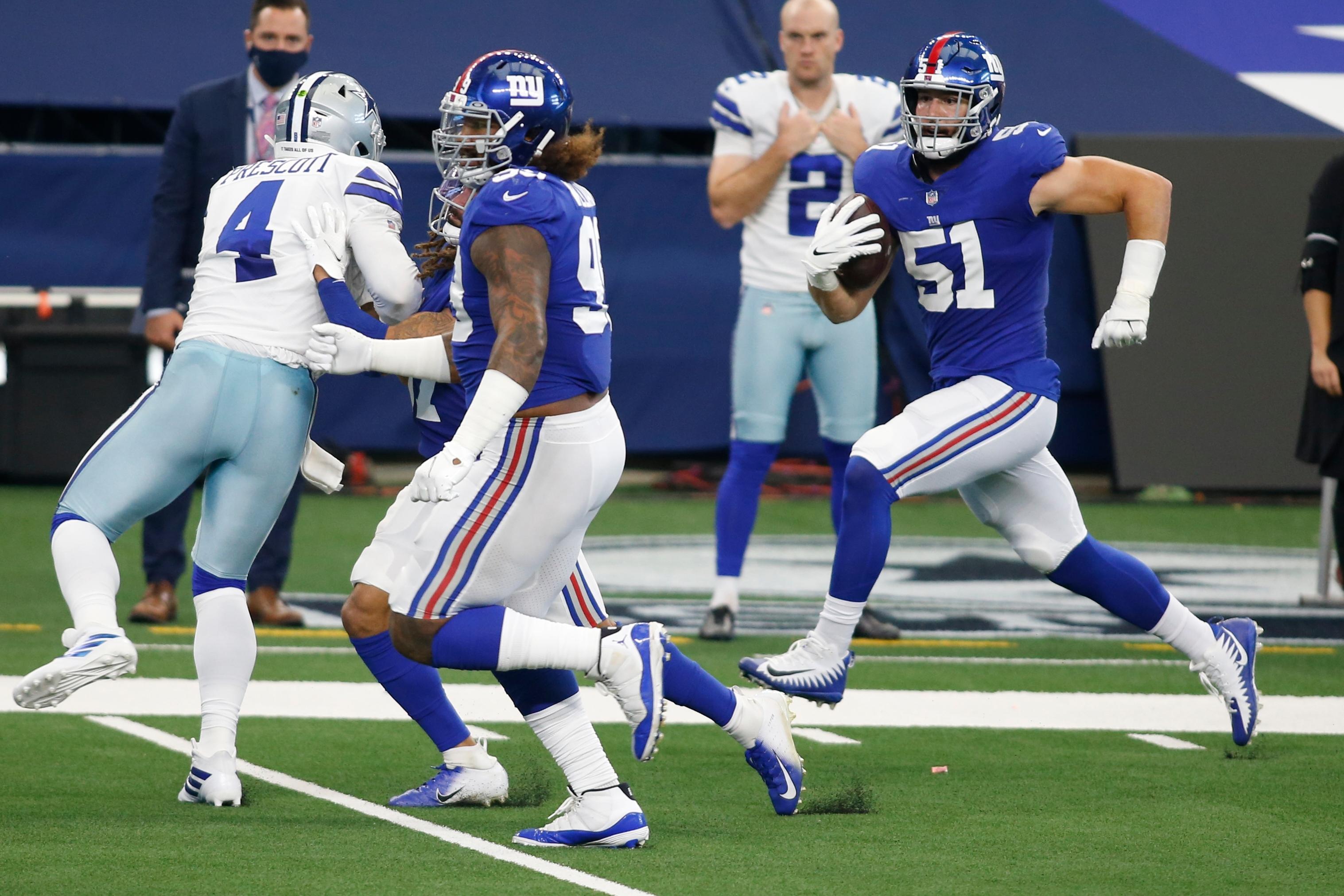 Oct 11, 2020; Arlington, Texas, USA; New York Giants outside linebacker Kyler Fackrell (51)s returns an interception for a touchdown against the Dallas Cowboys in the first quarter at AT&T Stadium