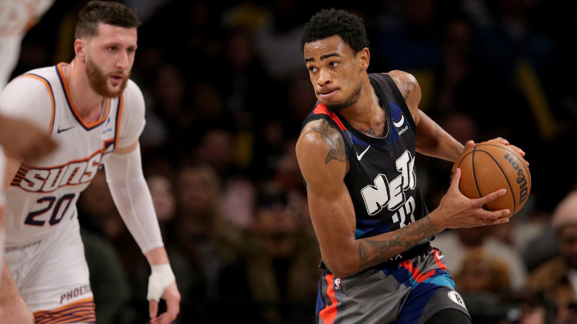 Jan 31, 2024; Brooklyn, New York, USA; Brooklyn Nets center Nic Claxton (33) controls the ball against Phoenix Suns center Jusuf Nurkic (20) during the third quarter at Barclays Center.