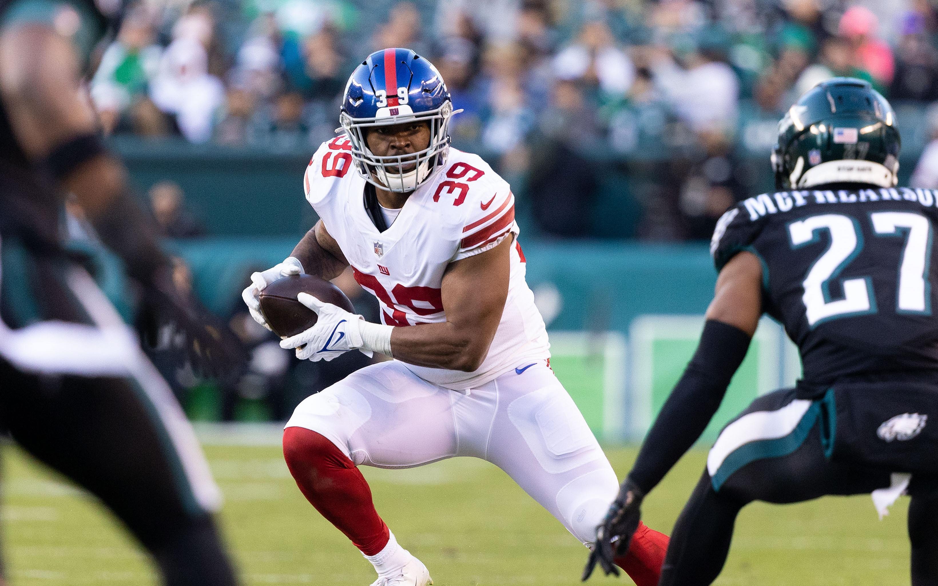 Dec 26, 2021; Philadelphia, Pennsylvania, USA; New York Giants fullback Elijhaa Penny (39) runs the ball against Philadelphia Eagles cornerback Zech McPhearson (27) during the fourth quarter at Lincoln Financial Field. Mandatory Credit: Bill Streicher-USA TODAY Sports