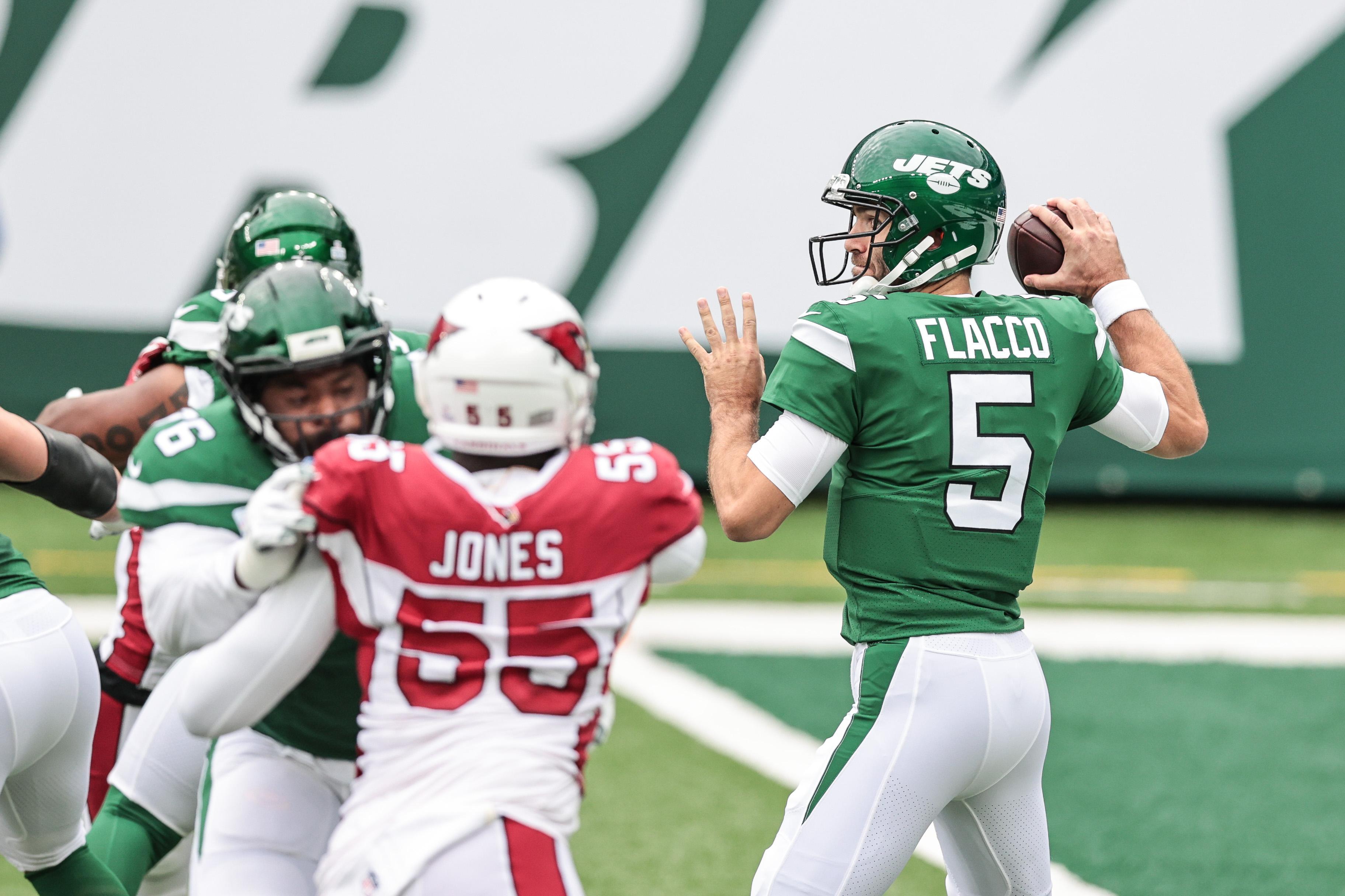 Oct 11, 2020; East Rutherford, New Jersey, USA; New York Jets quarterback Joe Flacco (5) throws the ball as Arizona Cardinals linebacker Chandler Jones (55) rushes during the first half at MetLife Stadium. Mandatory Credit: Vincent Carchietta-USA TODAY Sports