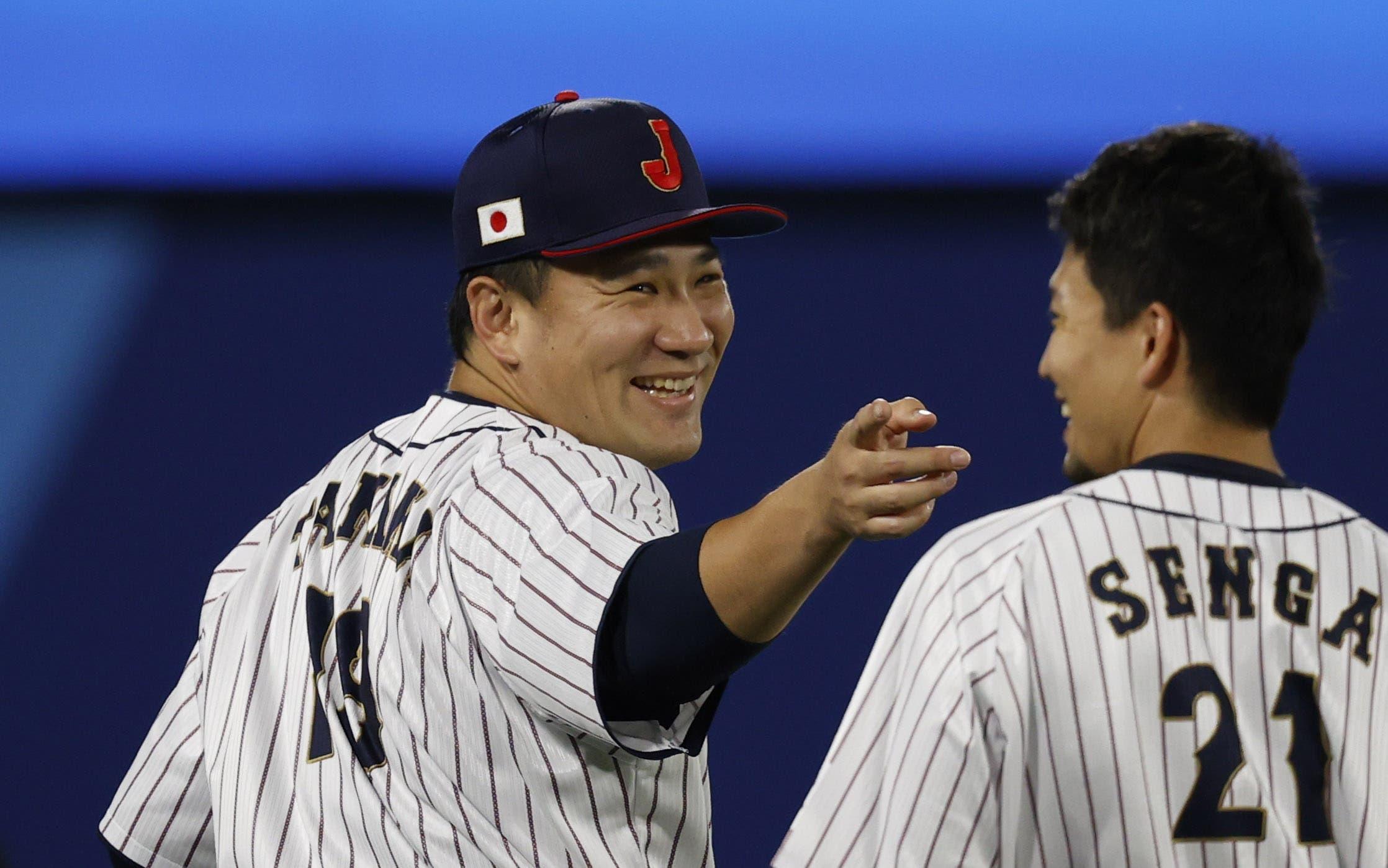 Aug 7, 2021; Yokohama, Japan; Team Japan pitcher Masahiro Tanaka (18) and Team Japan pitcher Koudai Senga (21) react before playing the USA in the baseball gold medal match during the Tokyo 2020 Olympic Summer Games at Yokohama Baseball Stadium. Mandatory Credit: Yukihito Taguchi-USA TODAY Sports / © Yukihito Taguchi-USA TODAY Sports