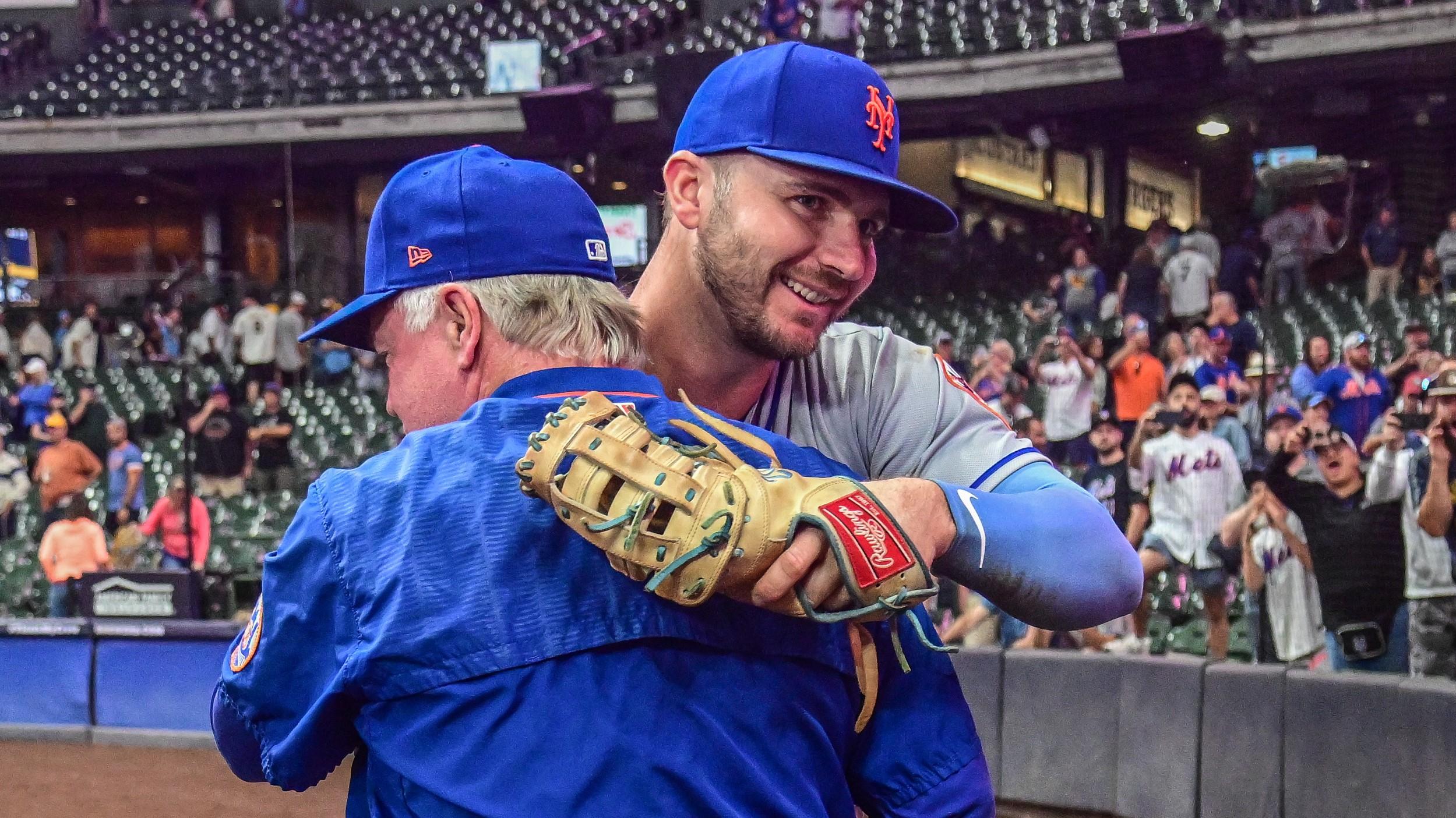 Sep 19, 2022; Milwaukee, Wisconsin, USA; New York Mets first baseman Pete Alonso (20) hugs manager Buck Showalter after the Mets clinched a playoff spot by beating the Milwaukee Brewers at American Family Field. Mandatory Credit: Benny Sieu-USA TODAY Sports