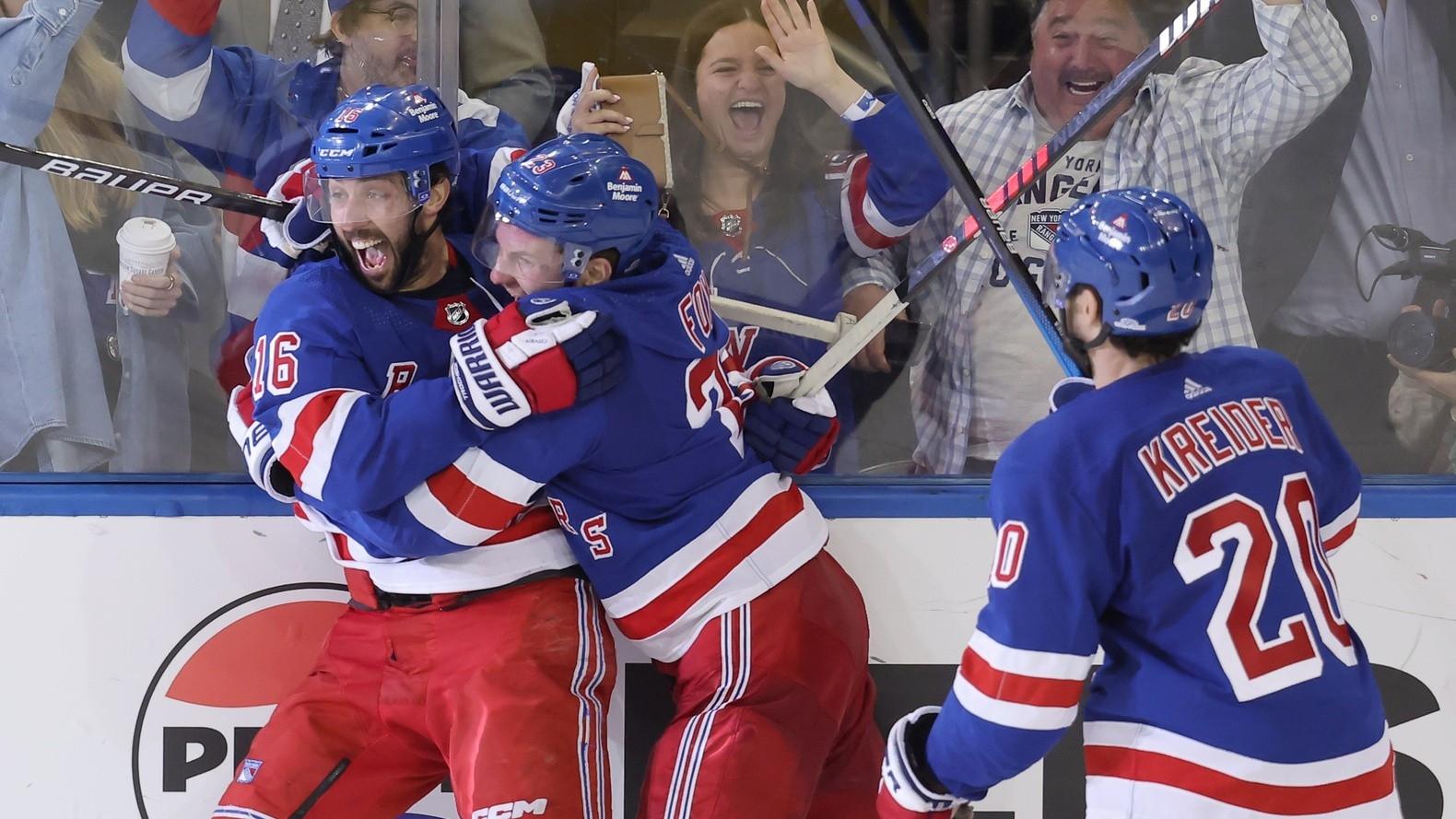 New York Rangers center Vincent Trocheck (16) celebrates his game winning goal against the Carolina Hurricanes with defenseman Adam Fox (23) and left wing Chris Kreider (20) during the second overtime of game two of the second round of the 2024 Stanley Cup Playoffs at Madison Square Garden.