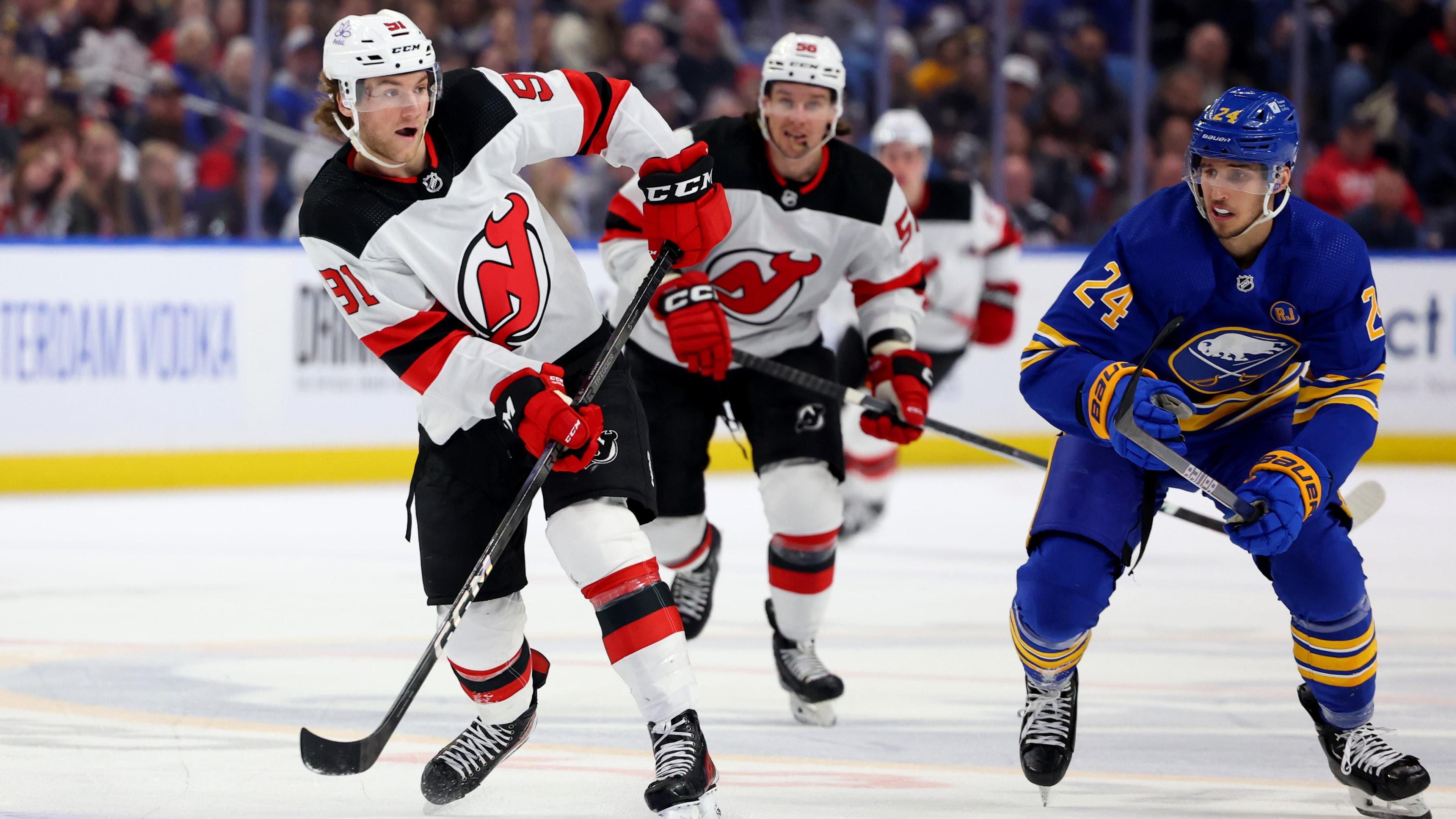 Mar 29, 2024; Buffalo, New York, USA; Buffalo Sabres center Dylan Cozens (24) watches as New Jersey Devils center Dawson Mercer (91) makes a pass during the third period at KeyBank Center. Mandatory Credit: Timothy T. Ludwig-USA TODAY Sports / © Timothy T. Ludwig-USA TODAY Sports