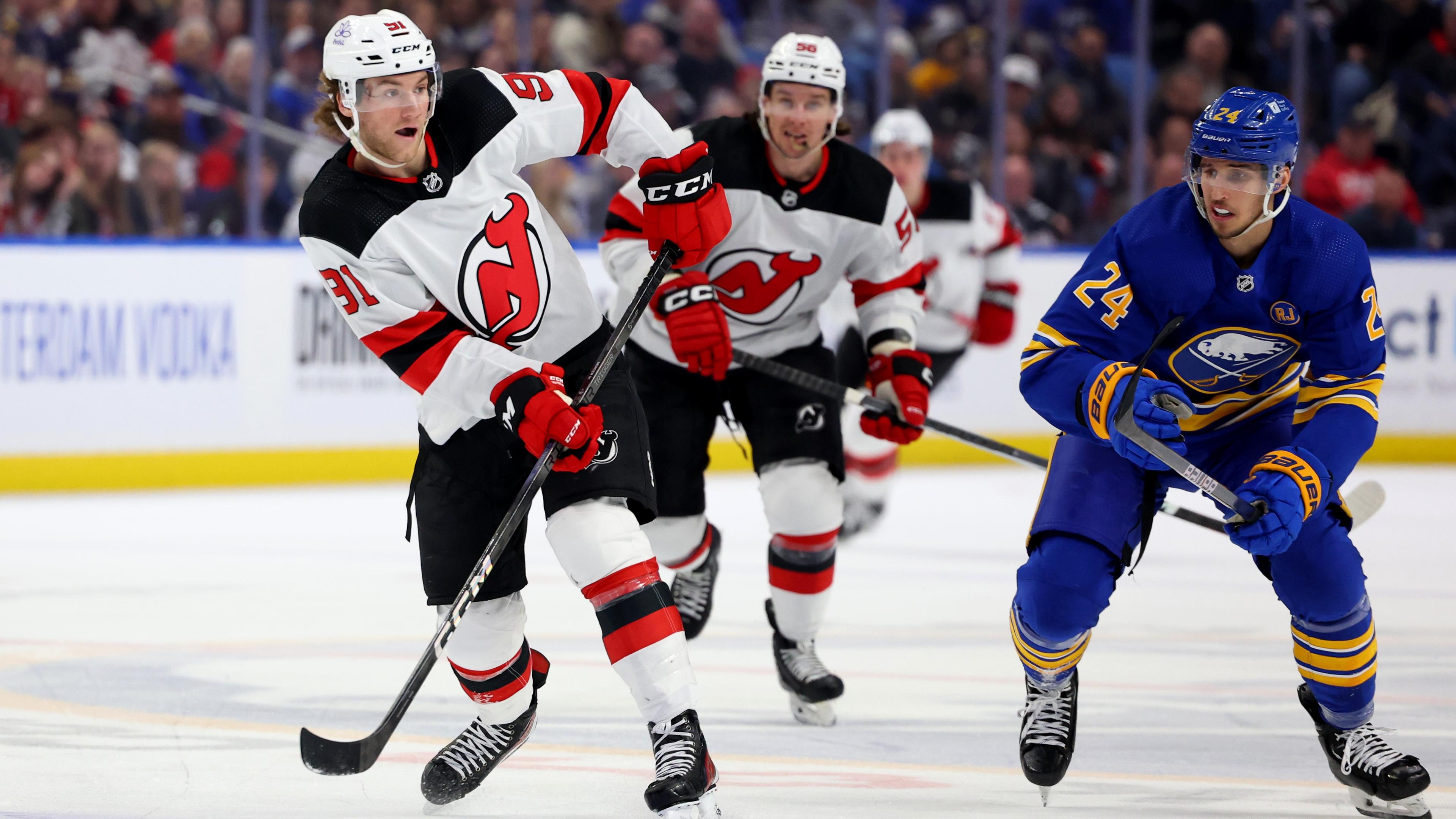 Mar 29, 2024; Buffalo, New York, USA; Buffalo Sabres center Dylan Cozens (24) watches as New Jersey Devils center Dawson Mercer (91) makes a pass during the third period at KeyBank Center. Mandatory Credit: Timothy T. Ludwig-USA TODAY Sports