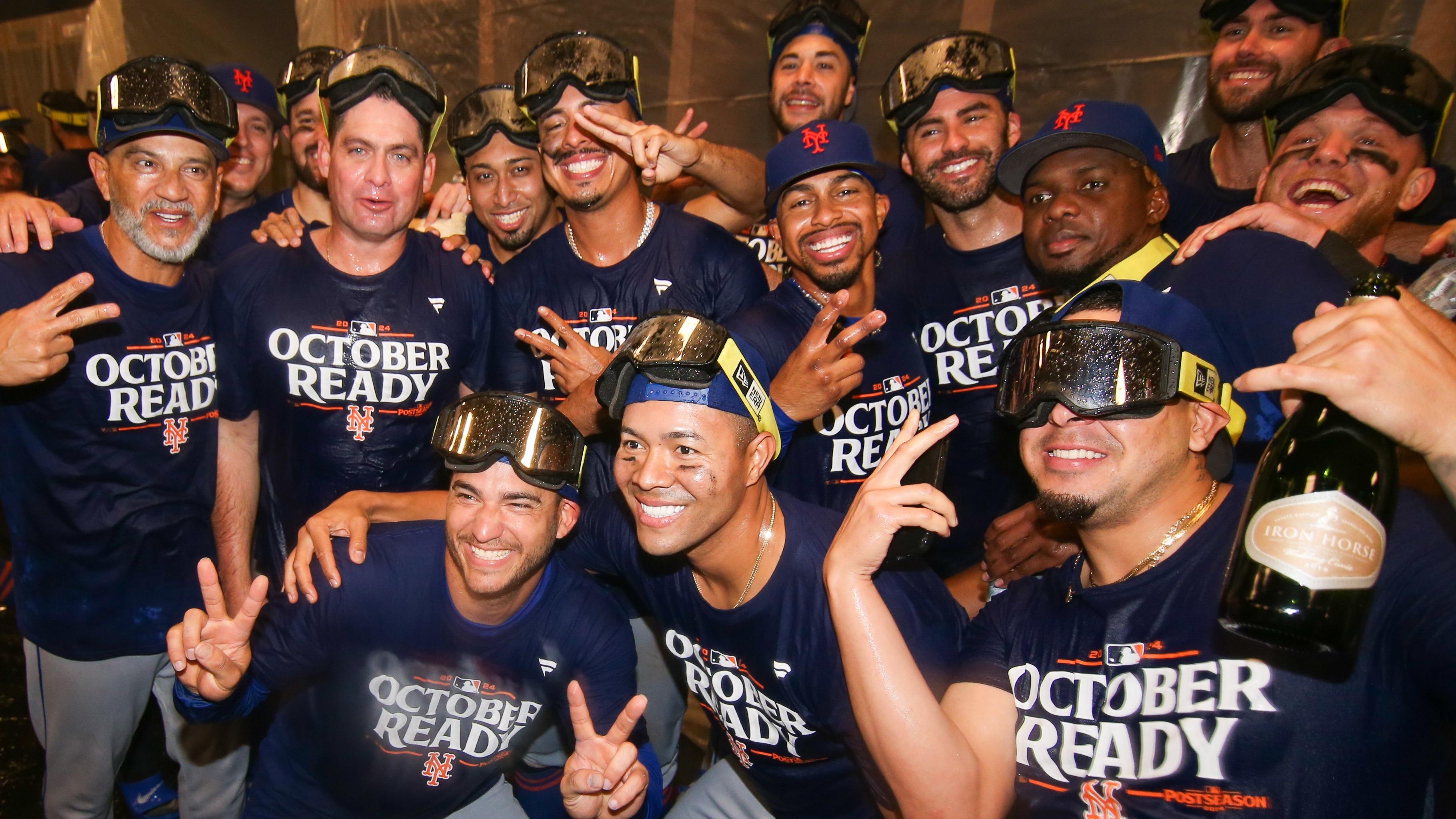 New York Mets players celebrate clinching a wild card playoff birth after a game against the Atlanta Braves at Truist Park