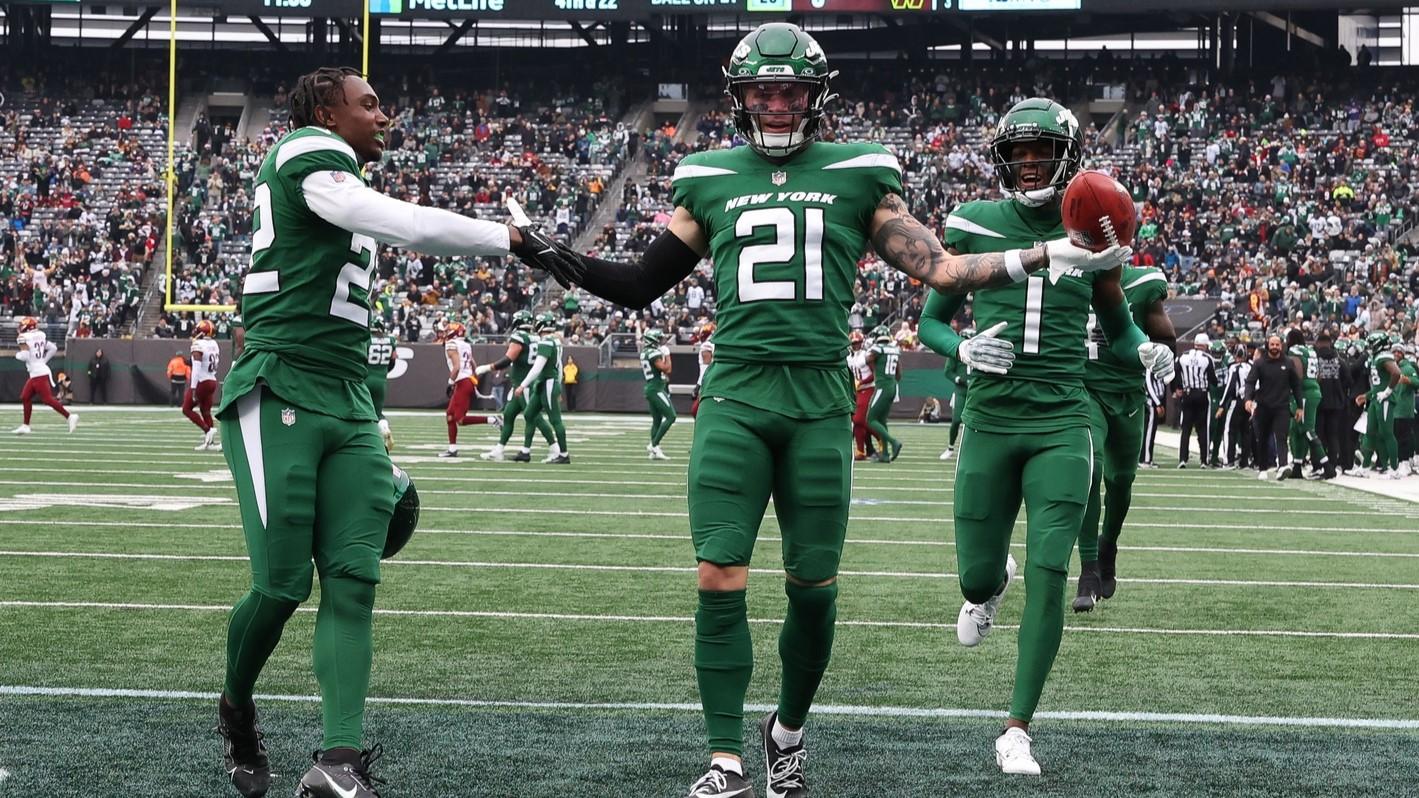 Dec 24, 2023; East Rutherford, New Jersey, USA; New York Jets safety Ashtyn Davis (21) celebrates his fumble recovery with safety Tony Adams (22) and cornerback Sauce Gardner (1) during the first half against the Washington Commanders at MetLife Stadium.