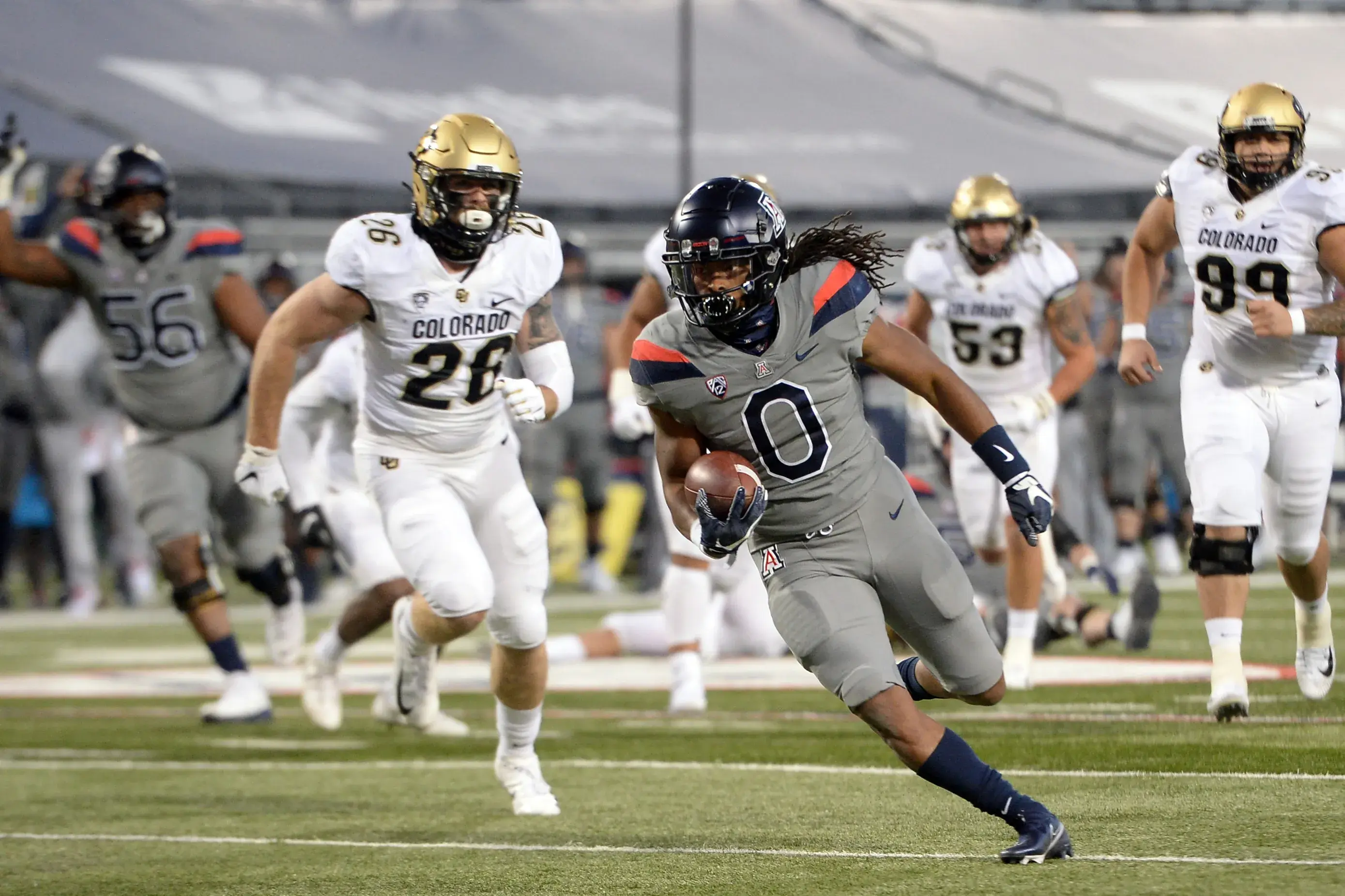 Dec 5, 2020; Tucson, Arizona, USA; Arizona Wildcats running back Gary Brightwell (0) runs for a touchdown against the Colorado Buffaloes during the first half at Arizona Stadium. Mandatory Credit: Joe Camporeale-USA TODAY Sports / Joe Camporeale-USA TODAY Sports