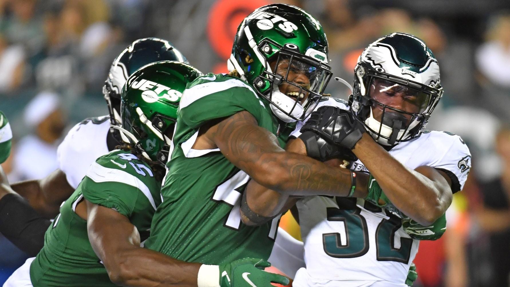 Philadelphia Eagles running back Jason Huntley (32) is wrapped by New York Jets linebacker Hamsah Nasirildeen (45) and linebacker Jamien Sherwood (44) during the fourth quarter at Lincoln Financial Field.