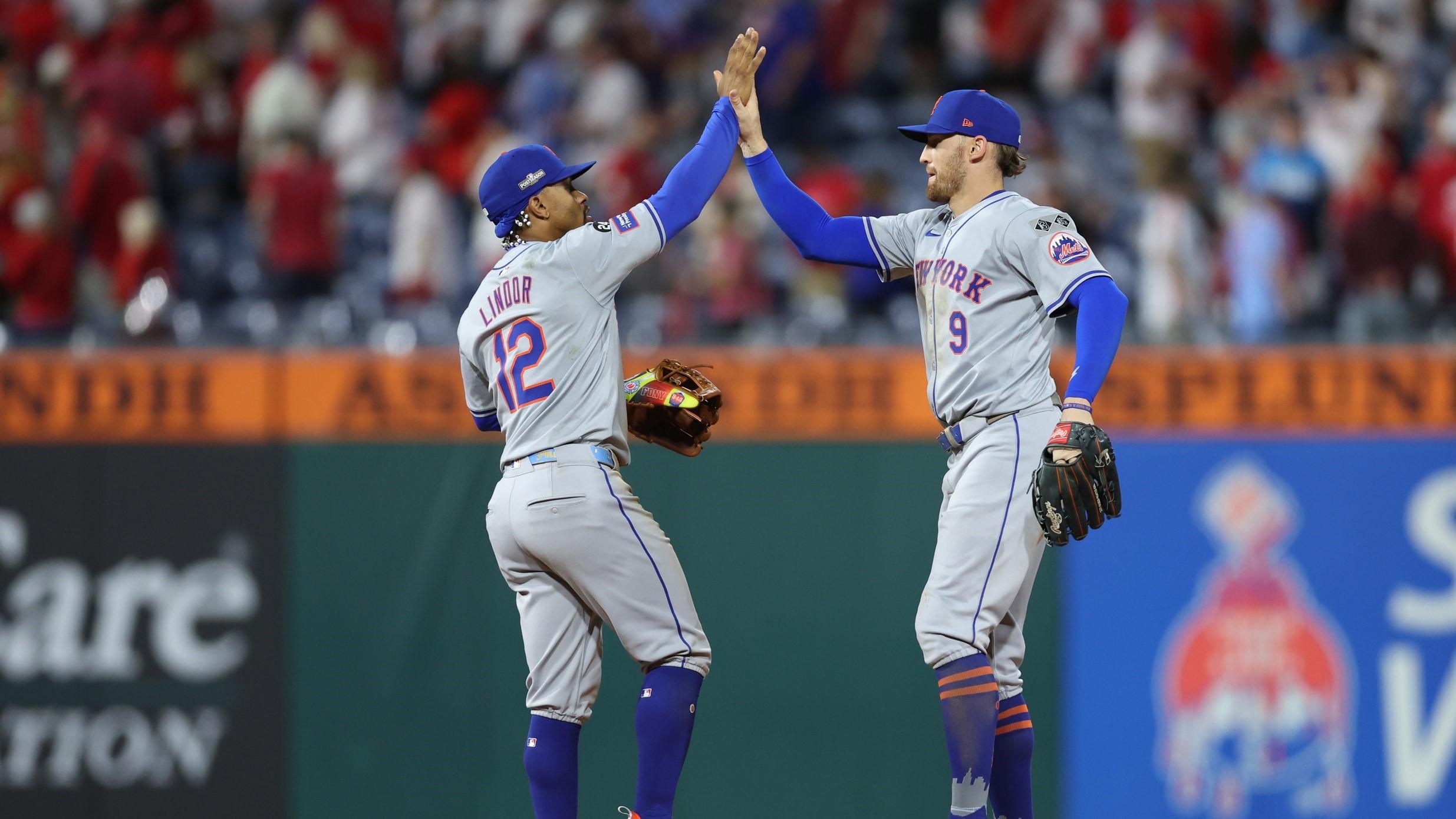 Oct 5, 2024; Philadelphia, PA, USA; New York Mets outfielder Brandon Nimmo (9) and New York Mets shortstop Francisco Lindor (12) celebrate defeating the Philadelphia Phillies in game one of the NLDS for the 2024 MLB Playoffs at Citizens Bank Park. 