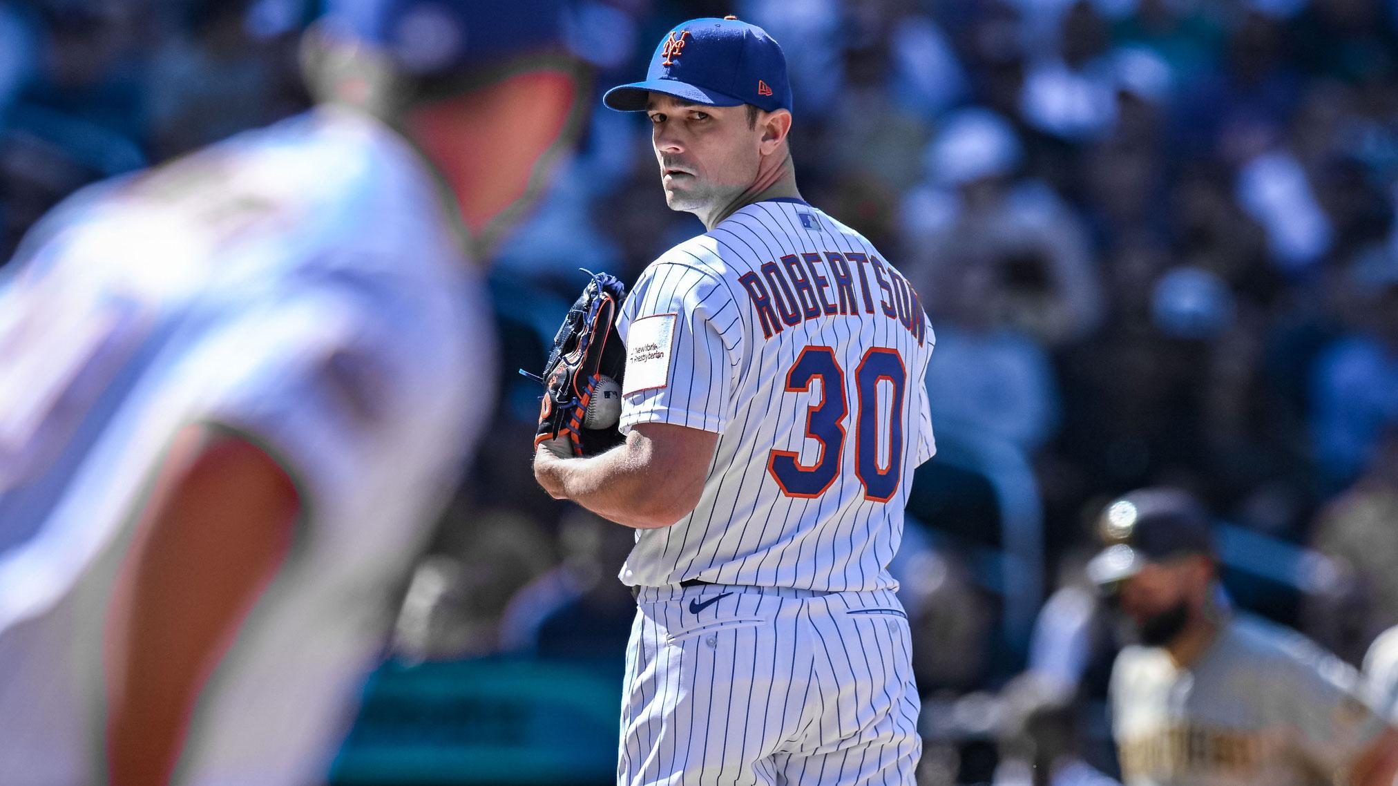 Apr 12, 2023; New York City, New York, USA; New York Mets relief pitcher David Robertson (30) checks the runner on first base during the seventh inning against the San Diego Padres at Citi Field.