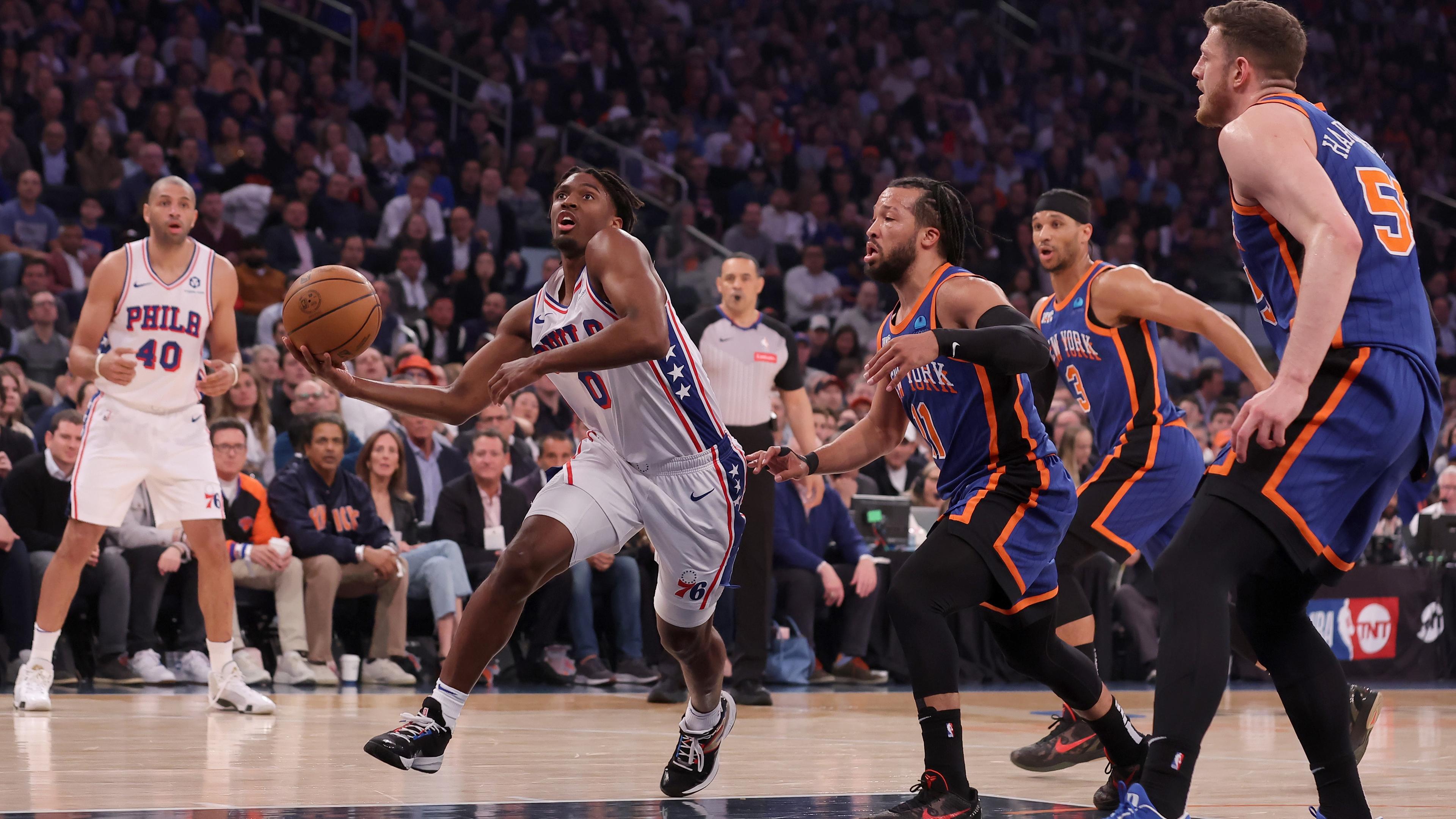 Apr 30, 2024; New York, New York, USA; Philadelphia 76ers guard Tyrese Maxey (0) drives to the basket against New York Knicks guards Jalen Brunson (11) and Josh Hart (3) and center Isaiah Hartenstein (55) during the first quarter of game 5 of the first round of the 2024 NBA playoffs at Madison Square Garden. Mandatory Credit: Brad Penner-USA TODAY Sports