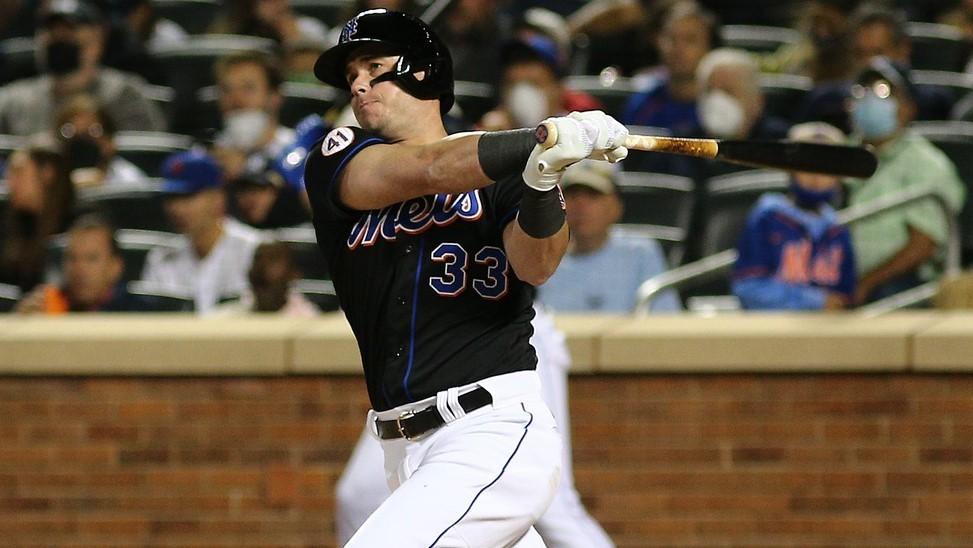 Sep 10, 2021; New York City, New York, USA; New York Mets catcher James McCann (33) hits an RBI double against the New York Yankees during the third inning at Citi Field.