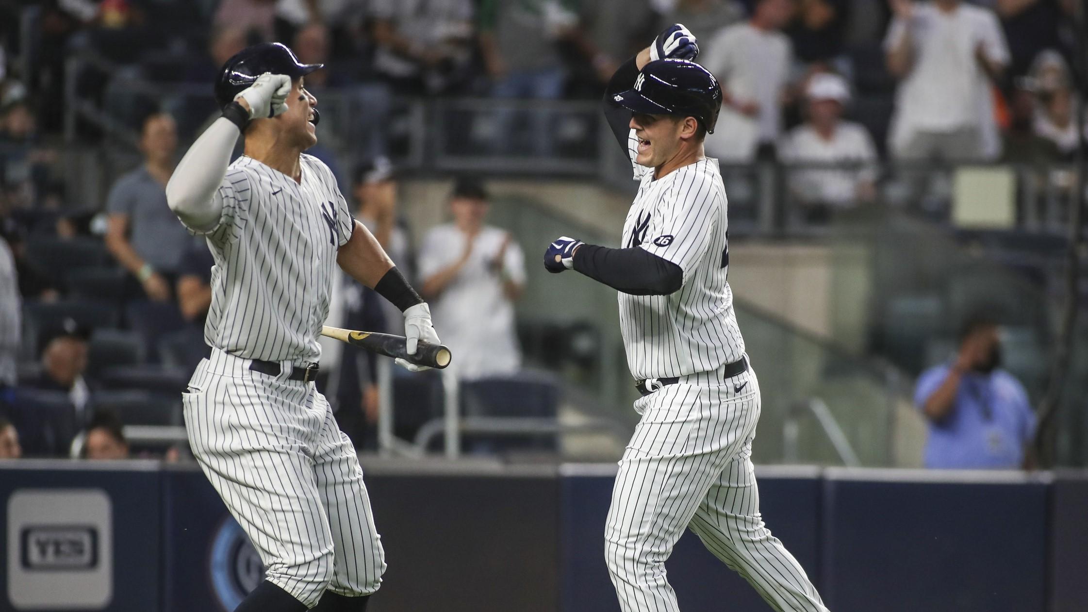 New York Yankees first baseman Anthony Rizzo (right) is greeted by right fielder Aaron Judge (left) after hitting a solo home run in the fourth inning against the Baltimore Orioles at Yankee Stadium.