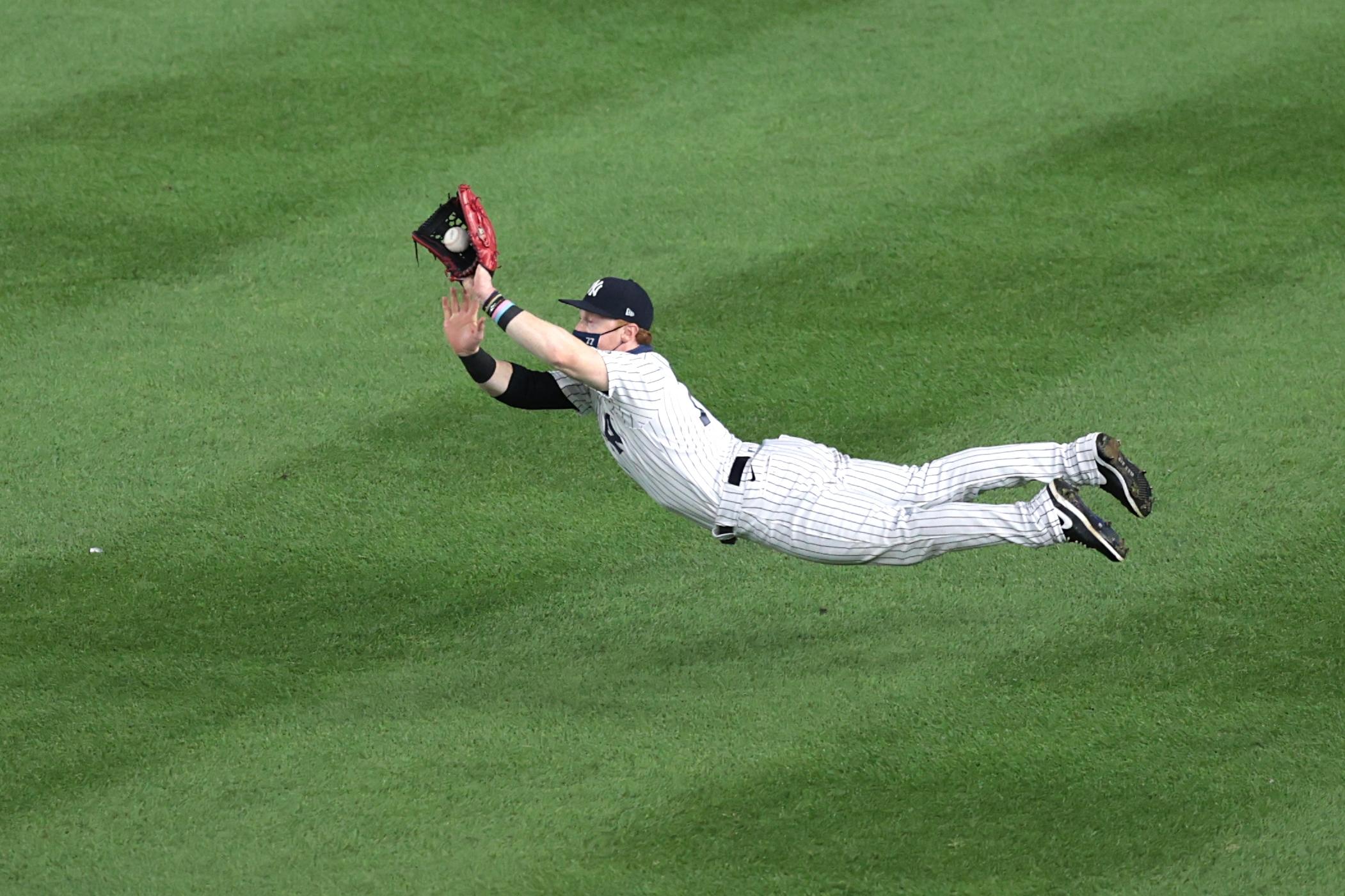 Sep 1, 2020; Bronx, New York, USA; New York Yankees right fielder Clint Frazier (77) catches the ball during the fifth inning against the Tampa Bay Rays at Yankee Stadium.