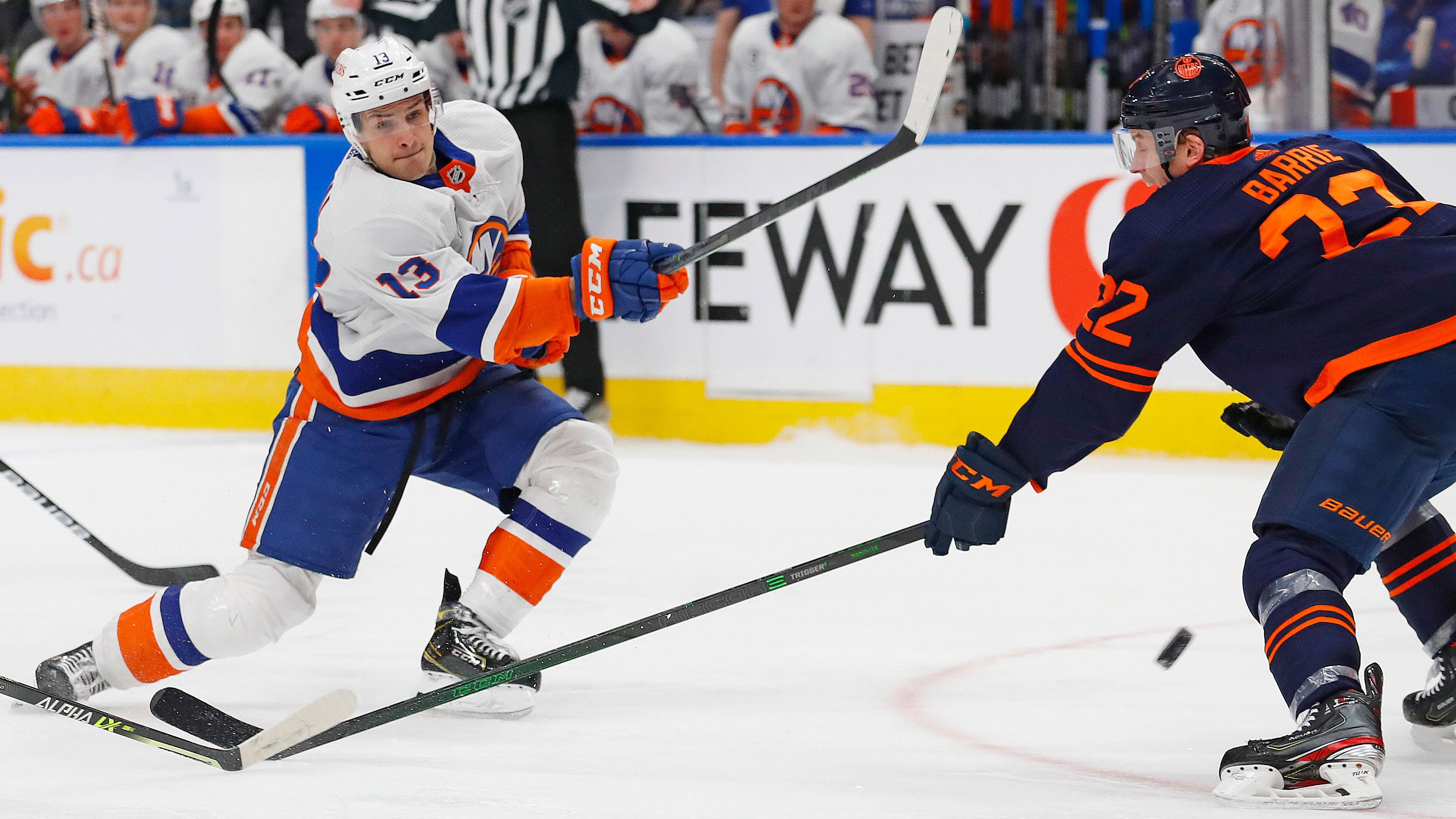 Feb 11, 2022; Edmonton, Alberta, CAN; New York Islanders forward Matt Barzal (13) takes a shot in front of Edmonton Oilers defensemen Tyson Barrie (22) during the second period at Rogers Place.