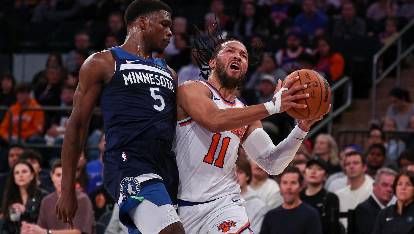 New York Knicks guard Jalen Brunson (11) is fouled by Minnesota Timberwolves guard Anthony Edwards (5) during the first half at Madison Square Garden.