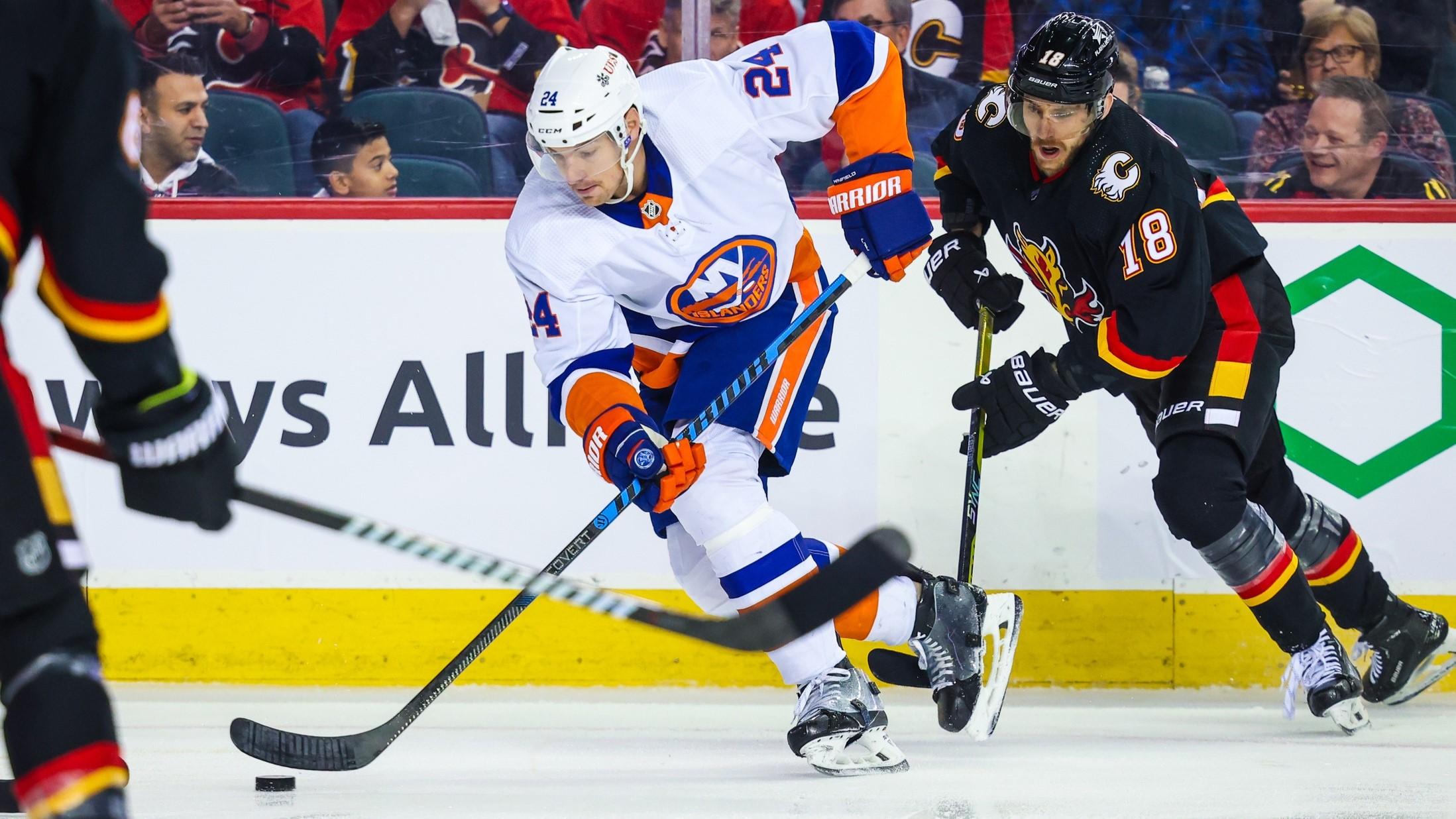 Nov 18, 2023; Calgary, Alberta, CAN; New York Islanders defenseman Scott Mayfield (24) controls the puck against the Calgary Flames during the first period at Scotiabank Saddledome.