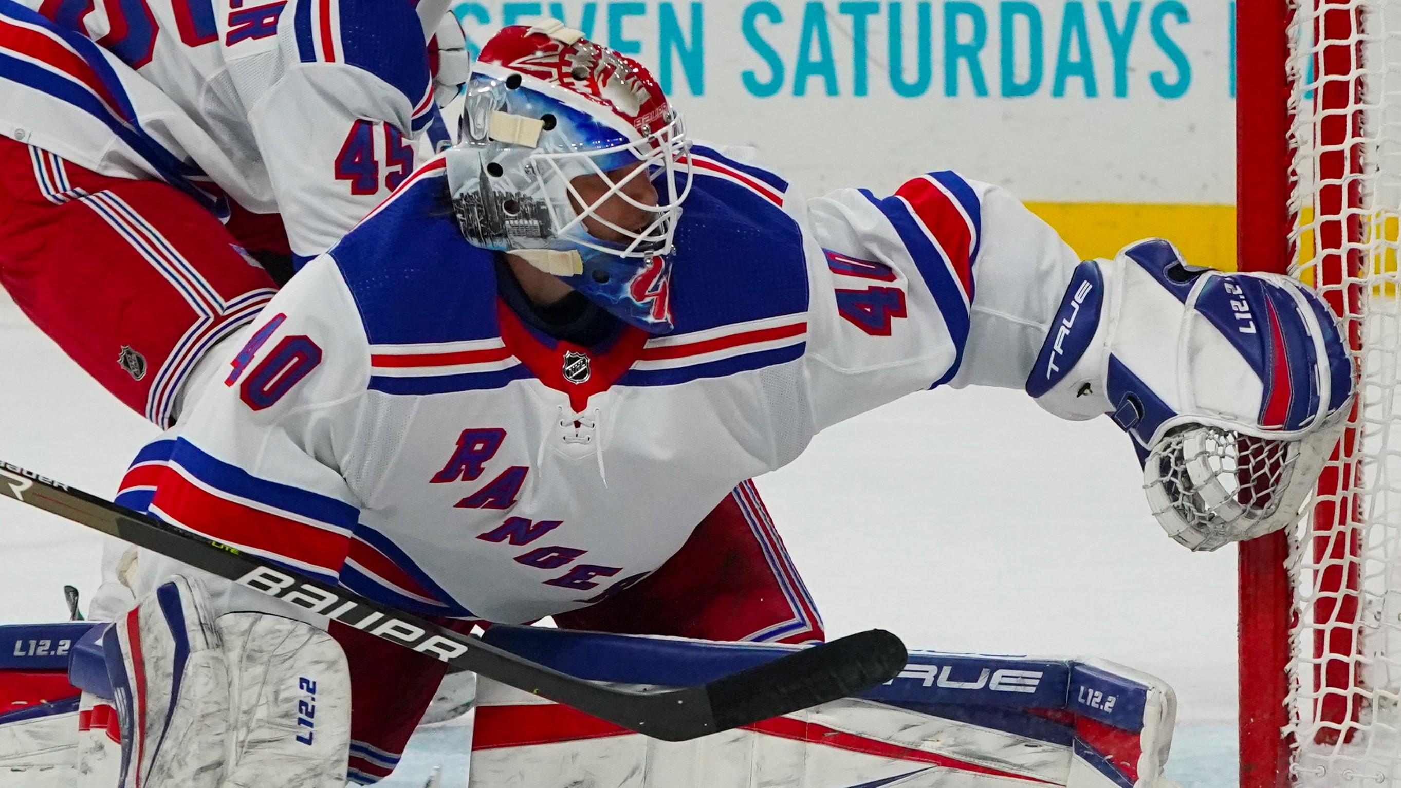 Mar 20, 2022; Raleigh, North Carolina, USA; New York Rangers goaltender Alexandar Georgiev (40) and defenseman Braden Schneider (45) watch the puck during the first period at PNC Arena. Mandatory Credit: James Guillory-USA TODAY Sports