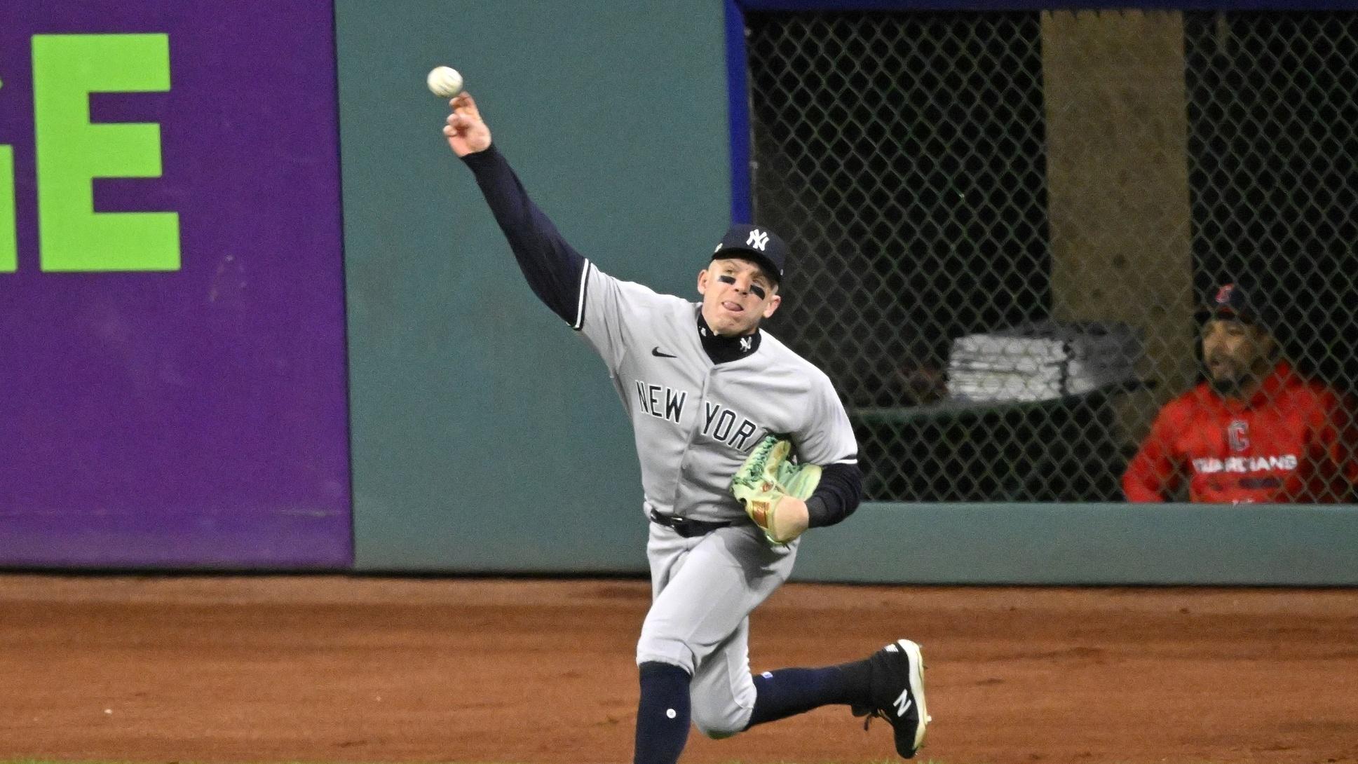 New York Yankees center fielder Harrison Bader makes a throw after a catch against the Cleveland Guardians in the ALDS.