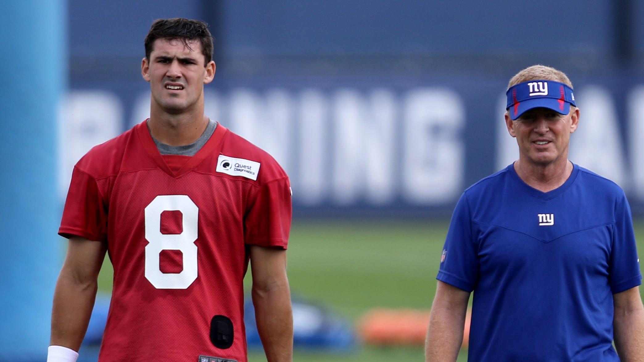 Quarterback Daniel Jones and Offensive Coordinator, Jason Garrett walk off the field after Giants practice, in East Rutherford.